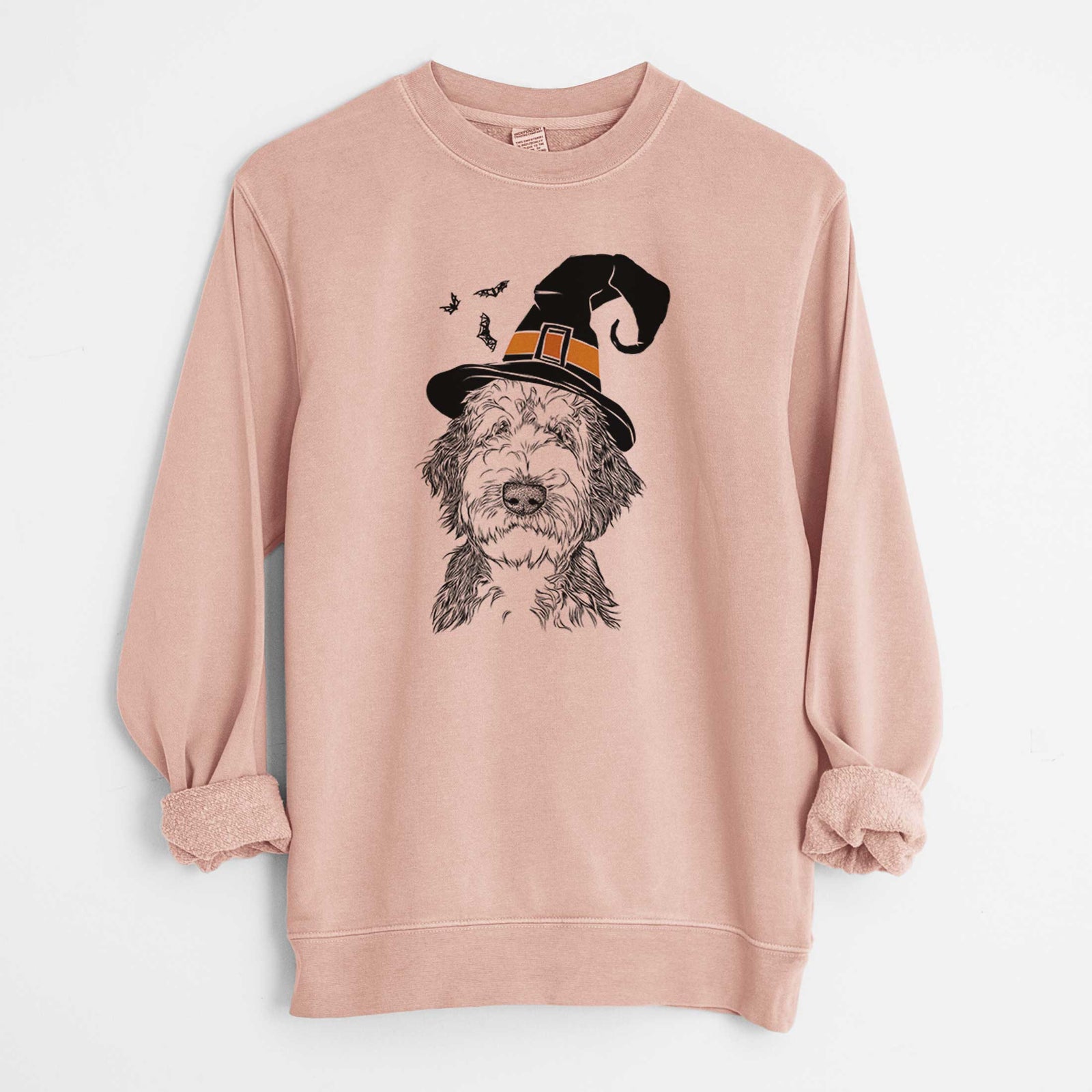 Hand-drawn sketch of Milo Fluff the Sheepadoodle wearing a witch hat on a Dusty Pink Unisex pigment dyed crew sweatshirt