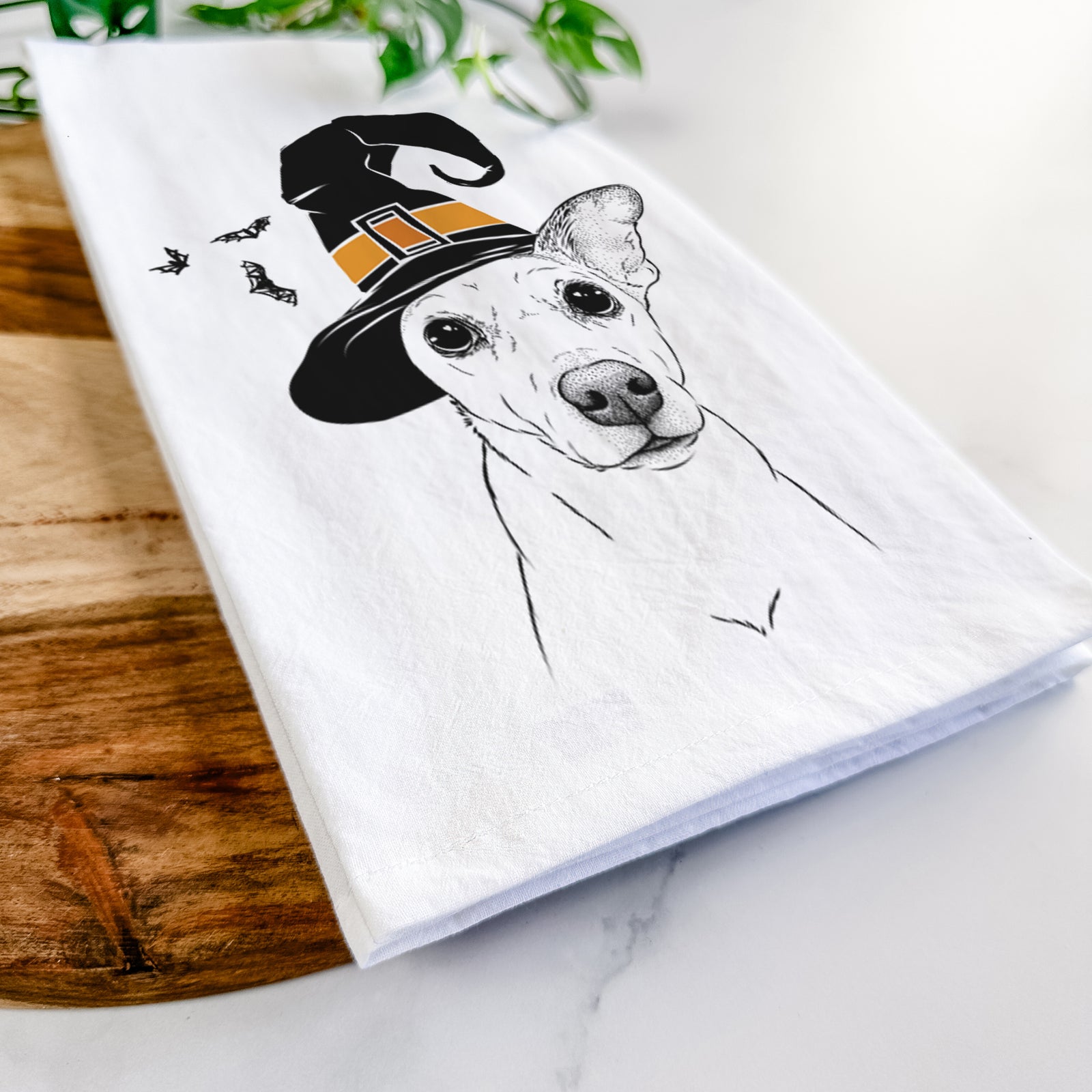 Hand-drawn sketch of Molly the Jack Russell Terrier wearing a witch hat on a tea towel