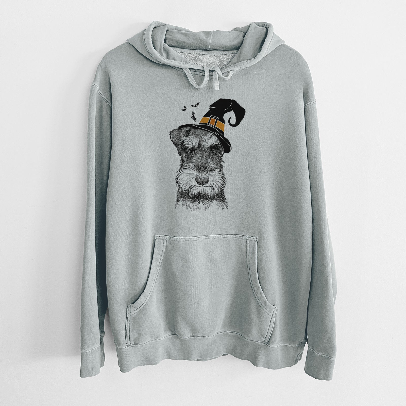 Hand-drawn sketch of Murphy the Mini Schnauzer wearing a witch hat on a Sage Unisex pigment dyed hoodie