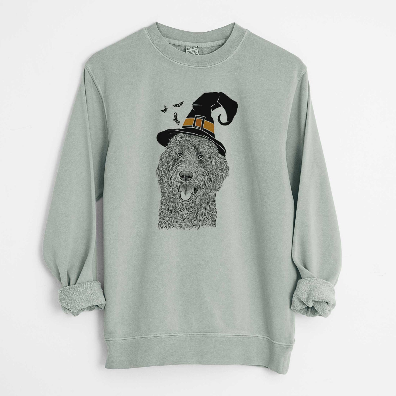 Hand-drawn sketch of Murr Dog the Labradoodle wearing a witch hat on a Sage Unisex pigment dyed crew sweatshirt