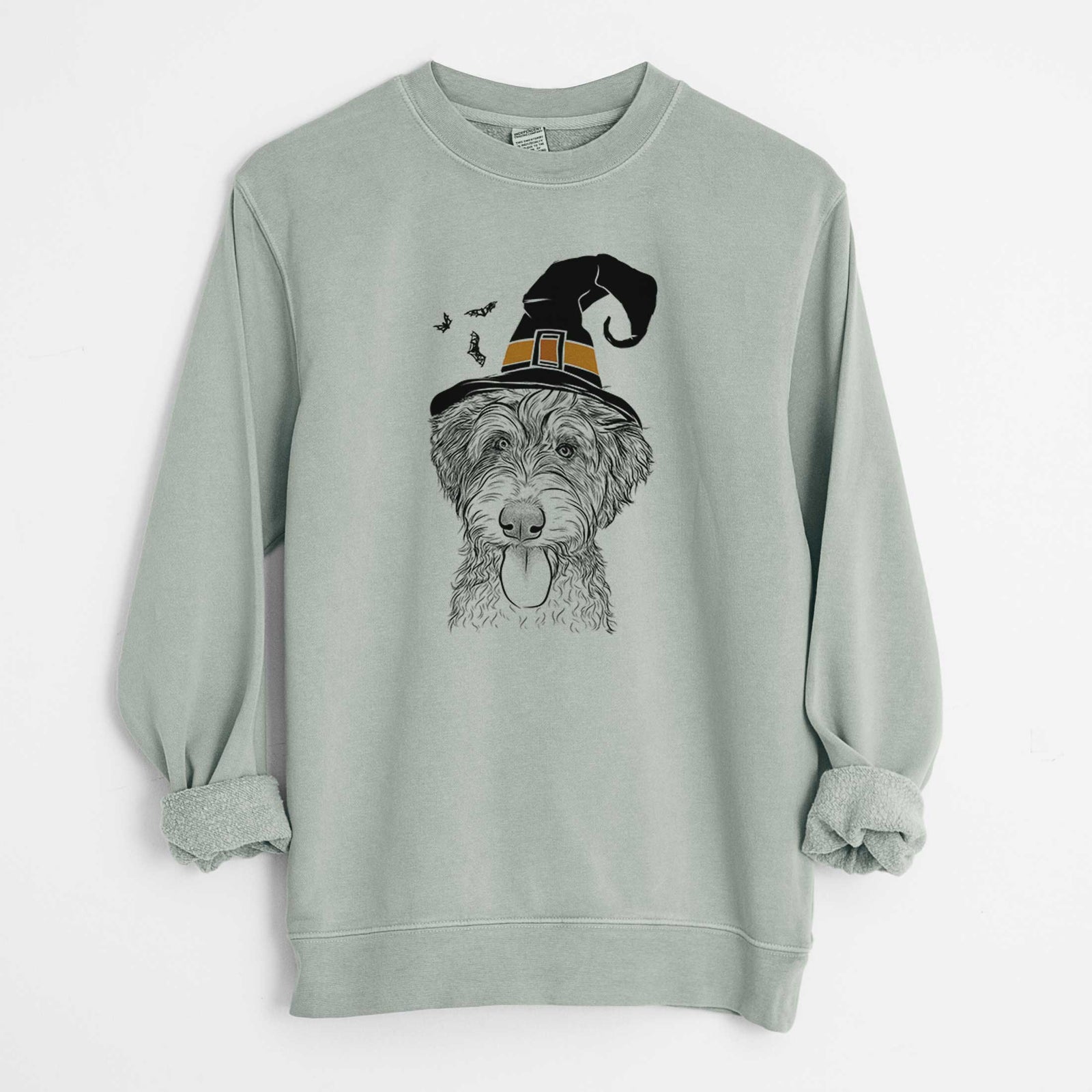 Hand-drawn sketch of Myrtle Mae the Aussiedoodle wearing a witch hat on a Sage Unisex pigment dyed crew sweatshirt