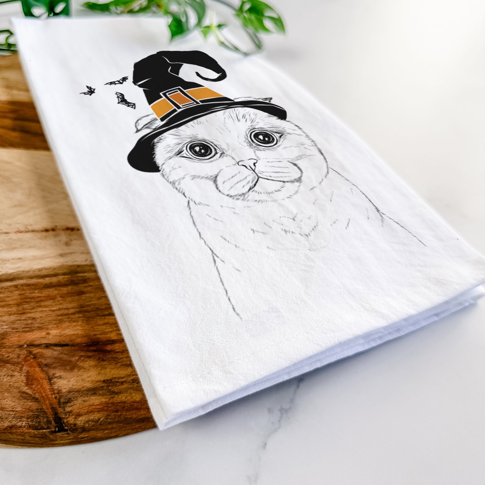 Hand-drawn sketch of Neko the Scottish Fold Cat wearing a witch hat on a tea towel