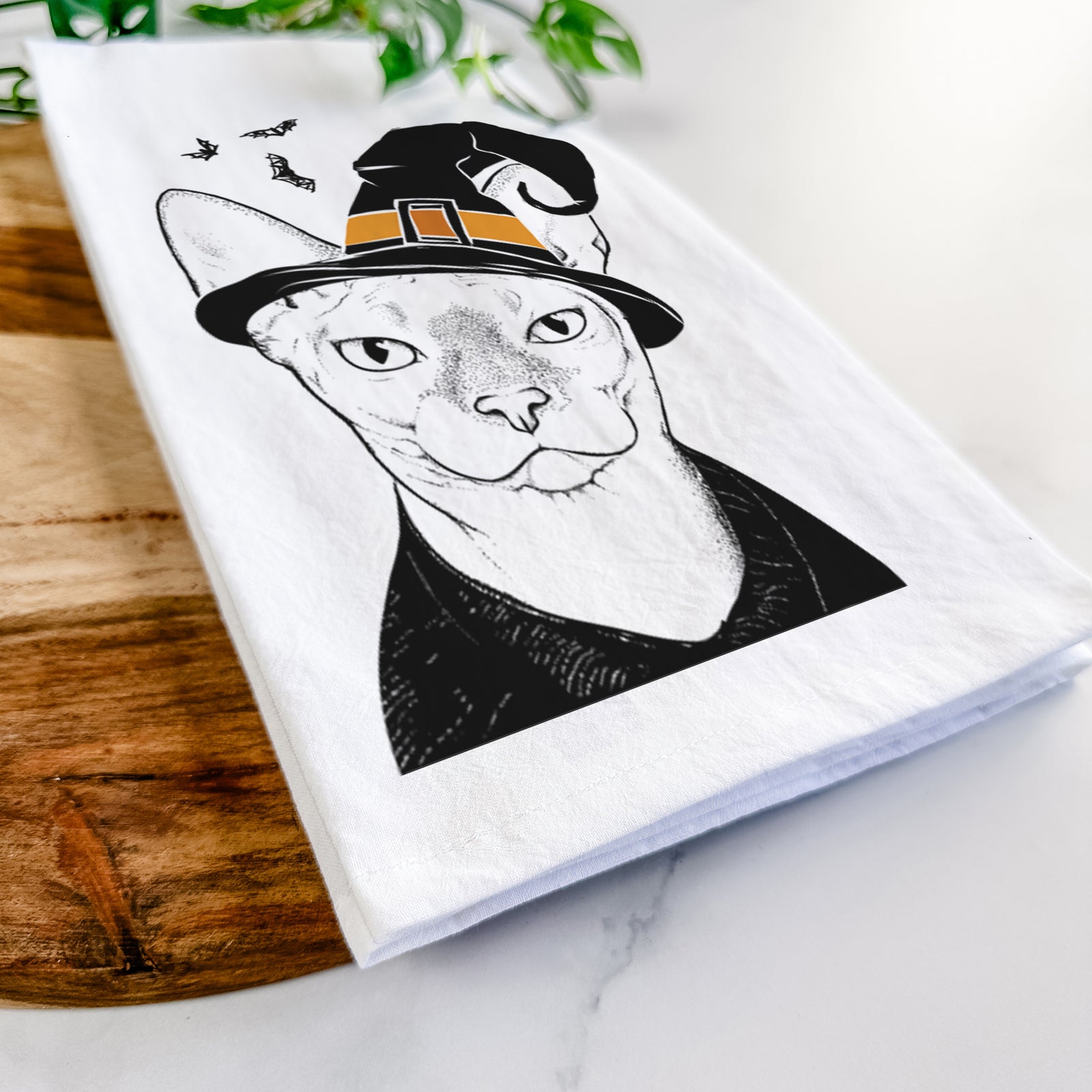 Hand-drawn sketch of Oliver Watson the Sphynx Cat wearing a witch hat on a tea towel