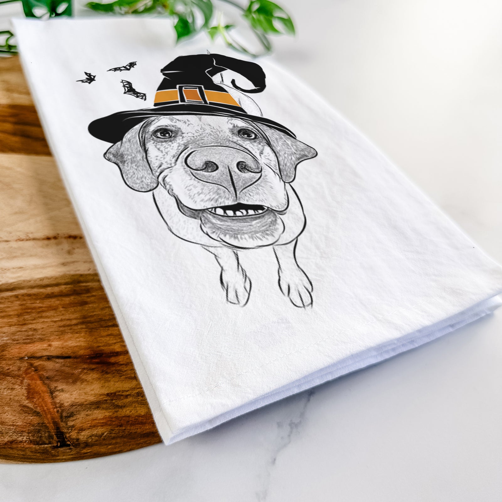 Hand-drawn sketch of Oquirrh the Vizsla wearing a witch hat on a tea towel