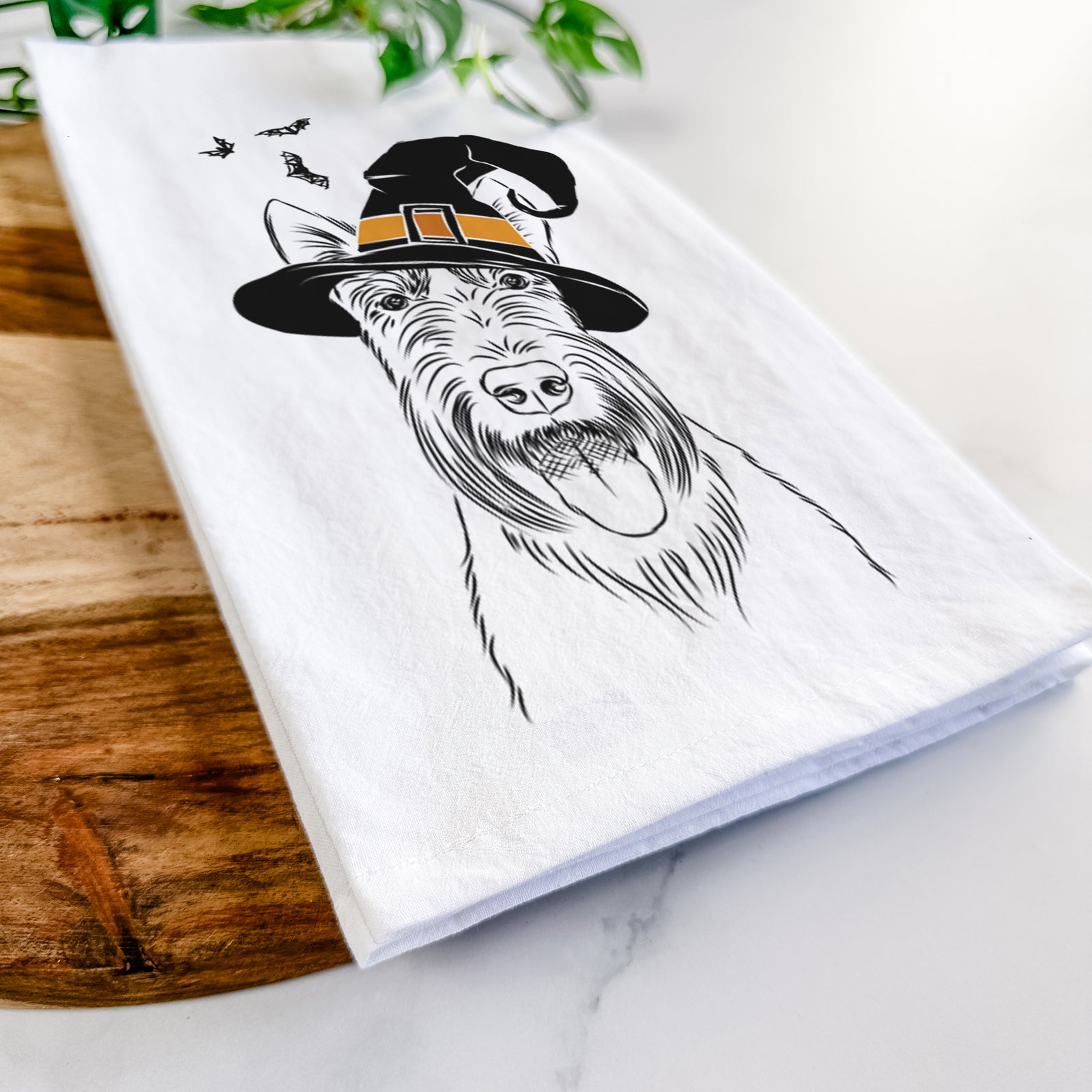 Hand-drawn sketch of Oswald the Scottish Terrier wearing a witch hat on a tea towel