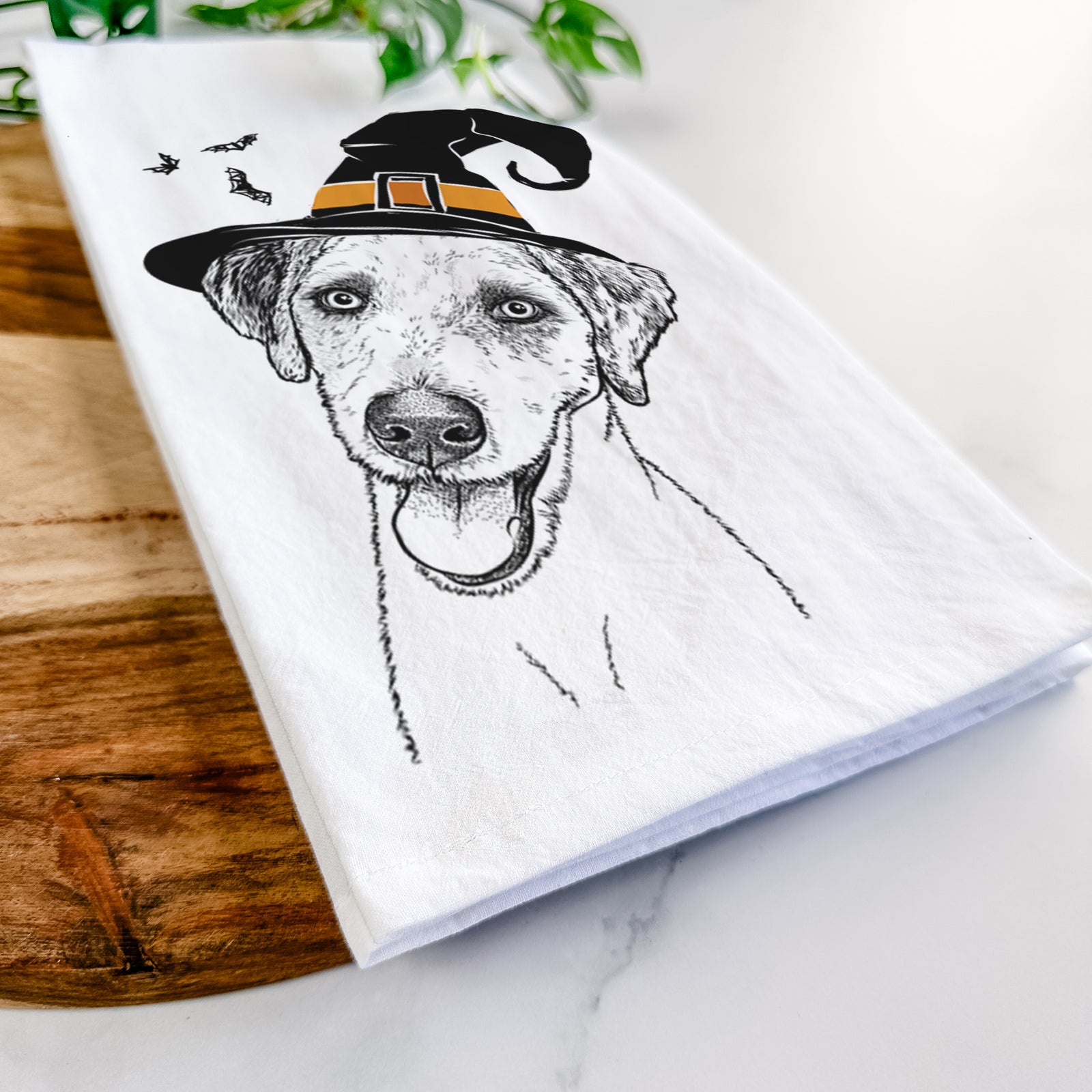 Hand-drawn sketch of Palm Palm the Aussiedoodle wearing a witch hat on a tea towel