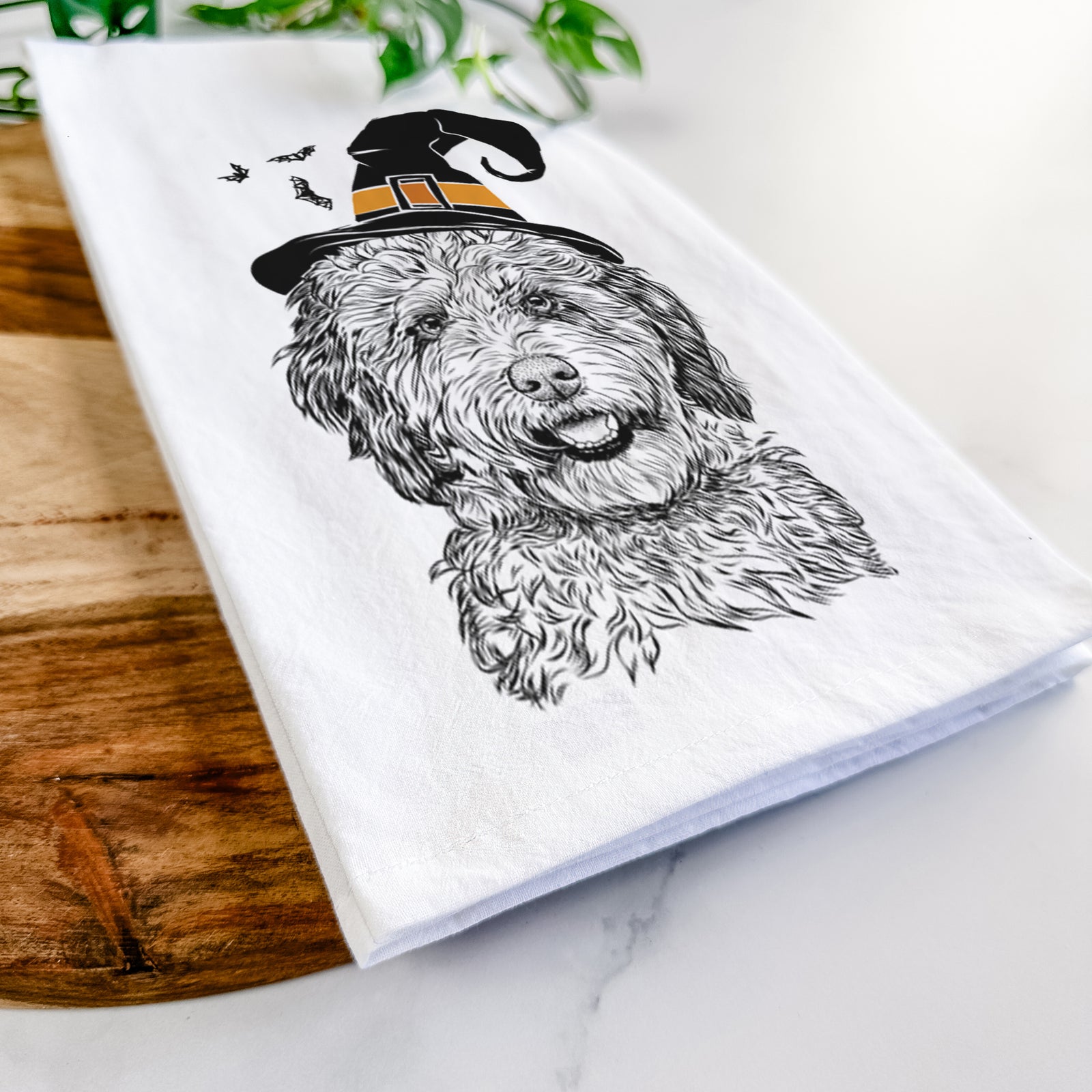 Hand-drawn sketch of Palmer the Aussiedoodle wearing a witch hat on a tea towel