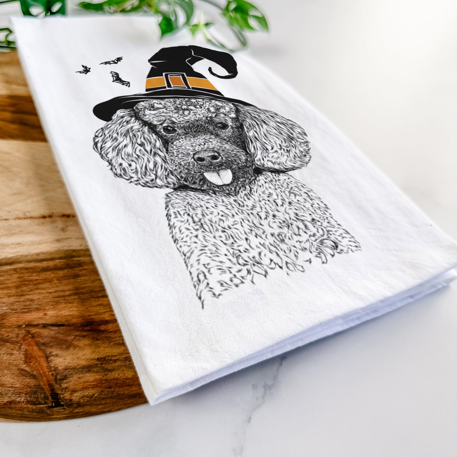 Hand-drawn sketch of George the Toy Poodle wearing a witch hat on a tea towel