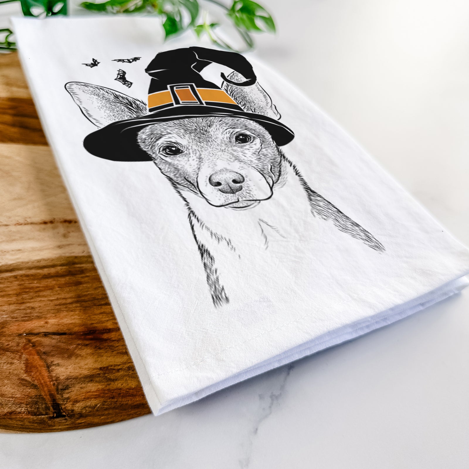 Hand-drawn sketch of Peanut the Chihuahua wearing a witch hat on a tea towel