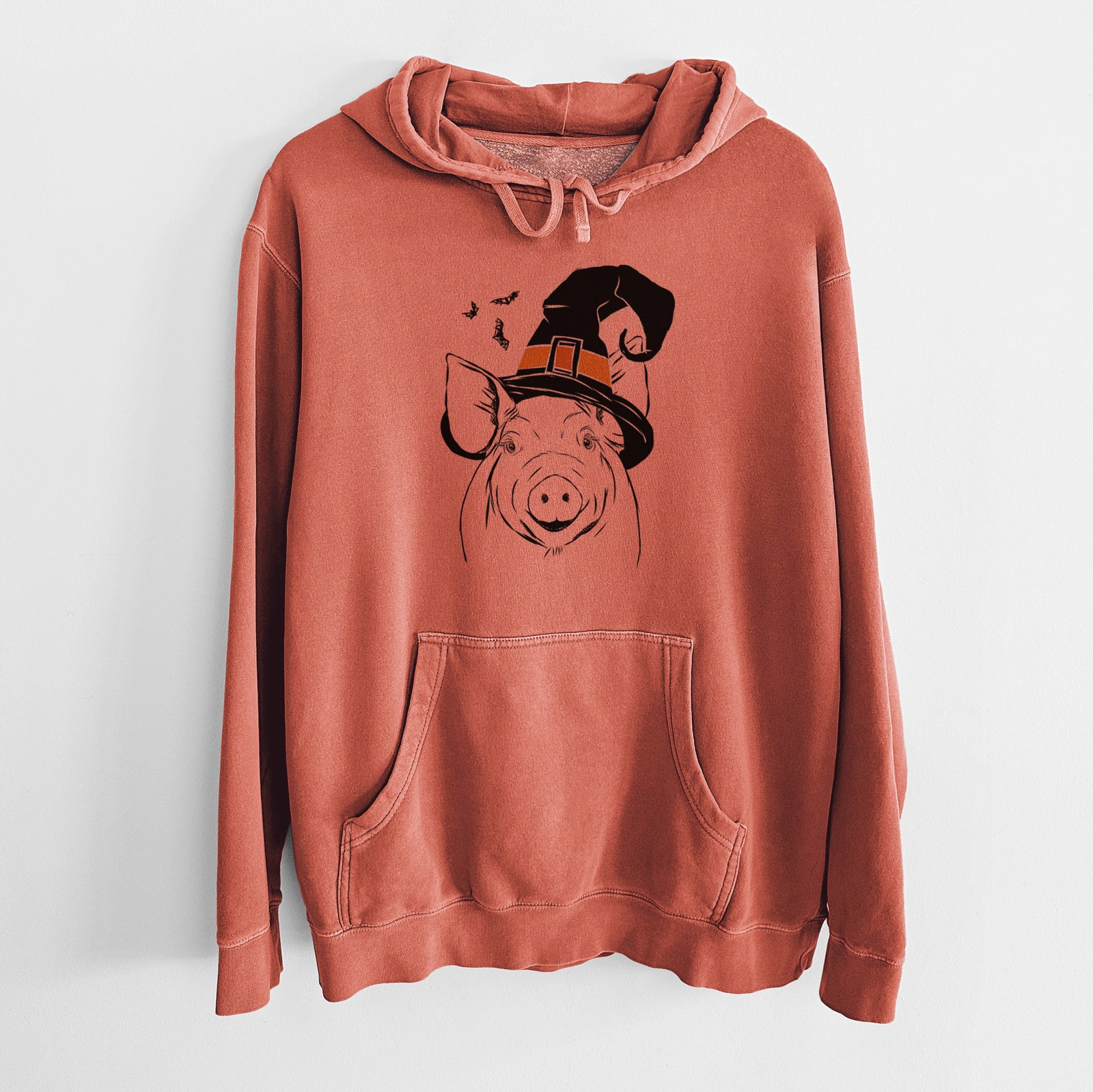 Hand-drawn sketch of Perry the Pig wearing a witch hat on an Amber Unisex pigment dyed hoodie
