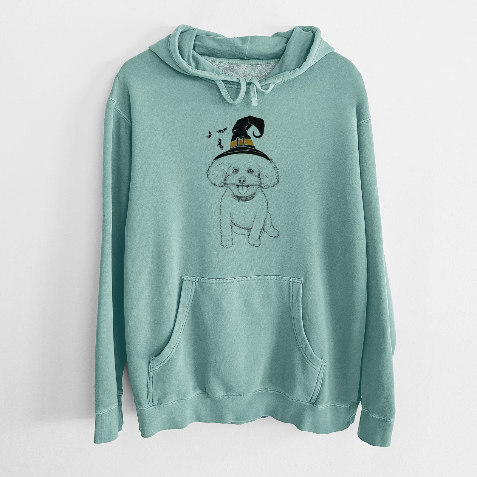 Hand-drawn sketch of Peyton the Bichon Frise wearing a witch hat on a Mint Unisex pigment dyed hoodie