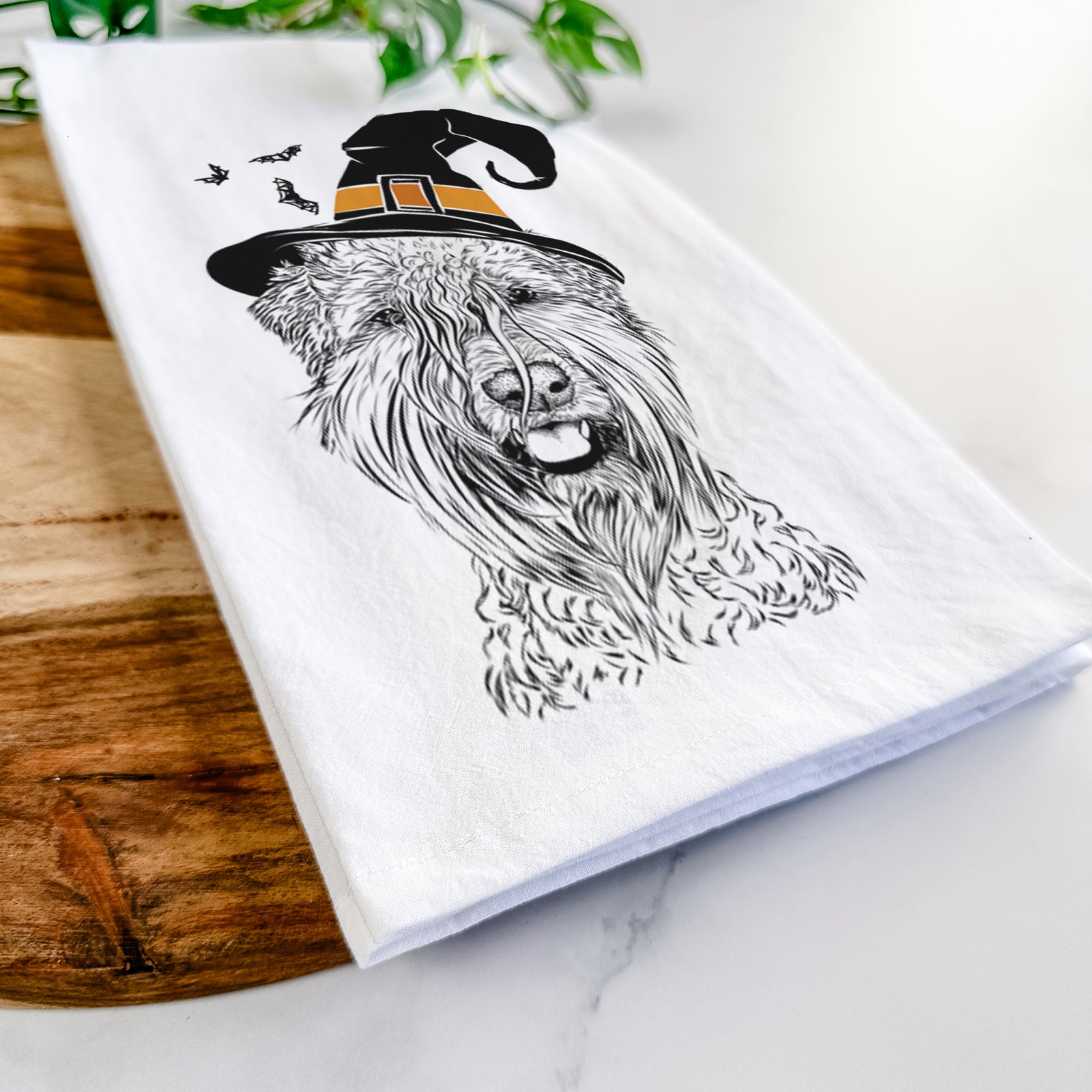Hand-drawn sketch of Pierre the Soft Coated Wheaten Terrier wearing a witch hat on a tea towel