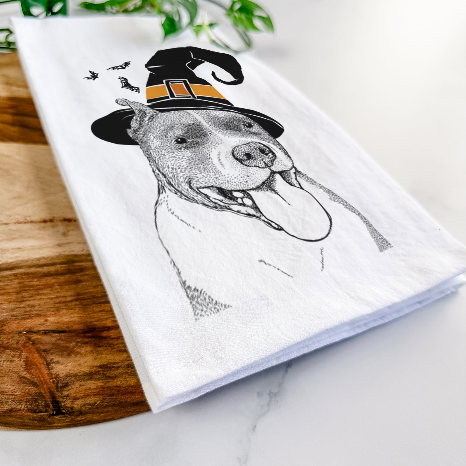 Hand-drawn sketch of Piggy the American Staffordshire Terrier wearing a witch hat on a tea towel