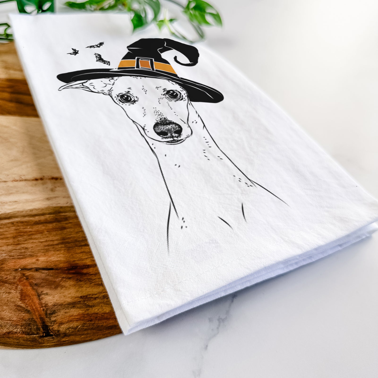 Hand-drawn sketch of Pip the Italian Greyhound wearing a witch hat on a tea towel