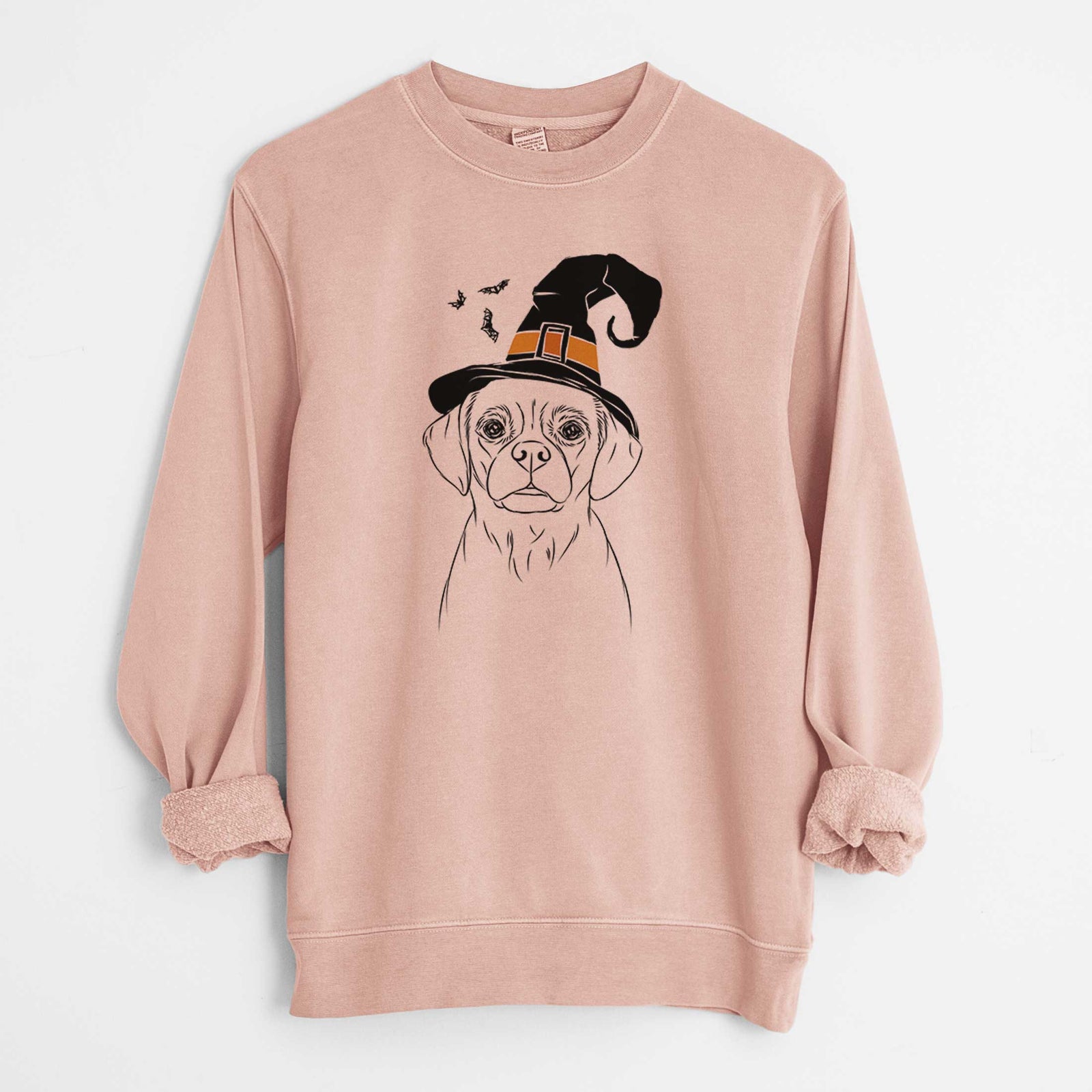 Hand-drawn sketch of Popcorn the Puggle wearing a witch hat on a Dusty Pink Unisex pigment dyed crew sweatshirt