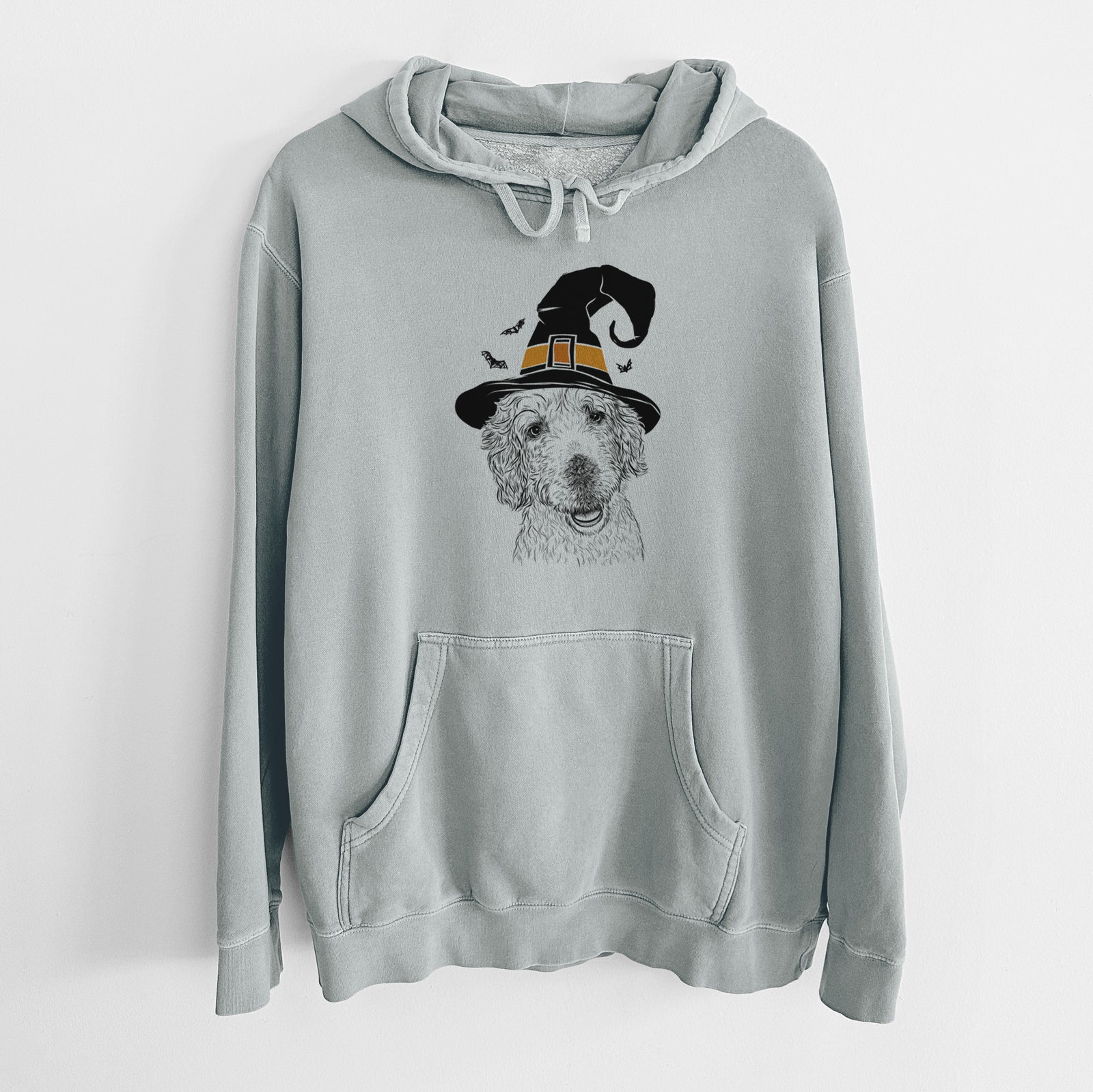 Hand-drawn sketch of Preston the Labradoodle wearing a witch hat on a Sage Unisex pigment dyed hoodie