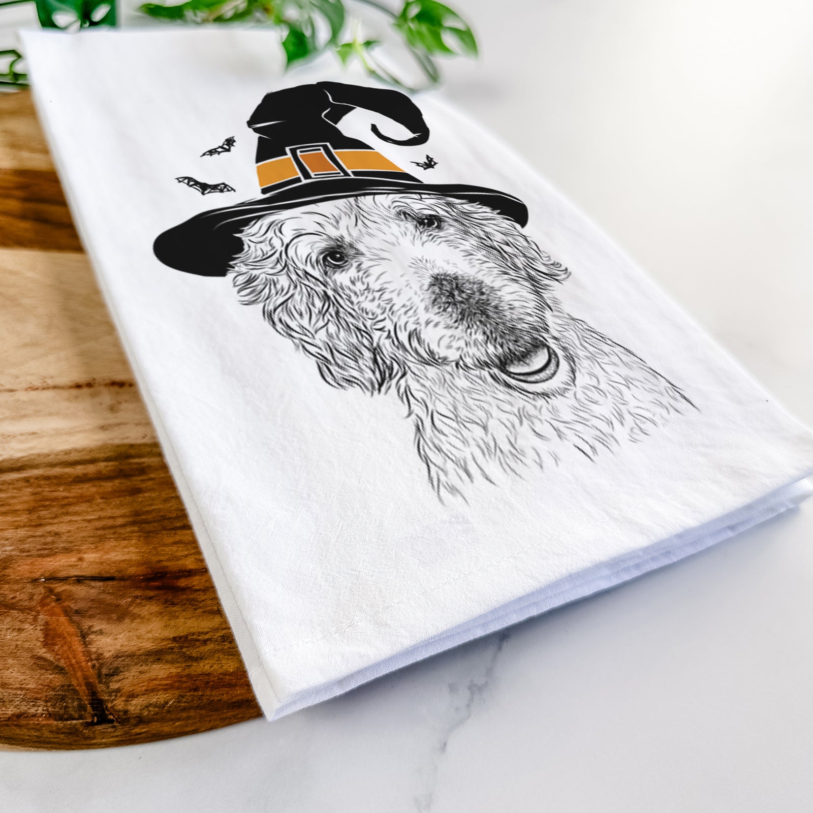 Hand-drawn sketch of Preston the Labradoodle wearing a witch hat on a tea towel