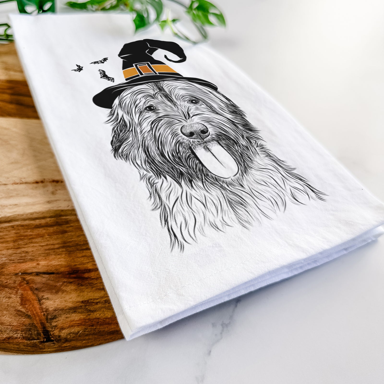 Hand-drawn sketch of Puig the Catalan Sheepdog wearing a witch hat on a tea towel