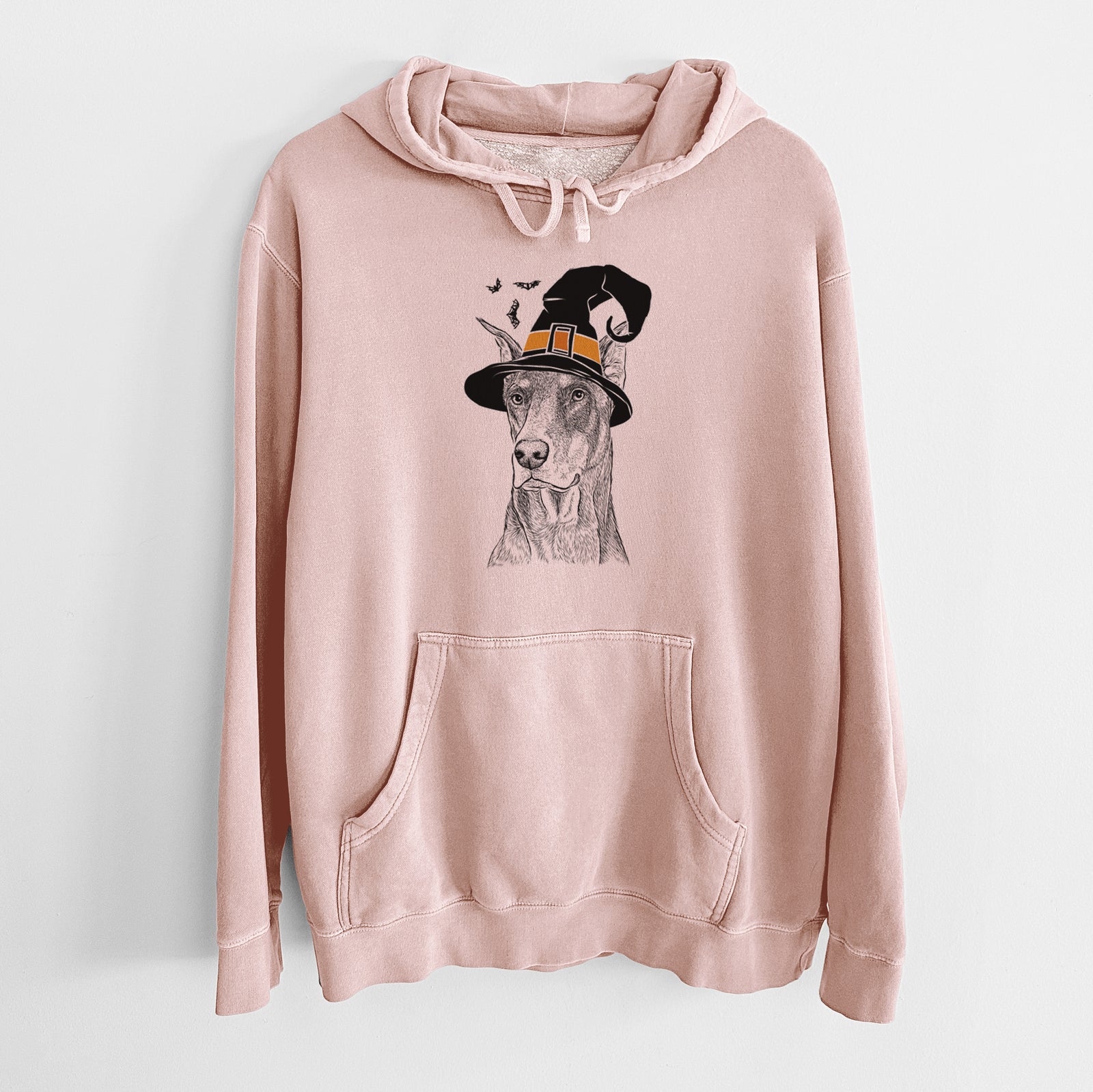 Hand-drawn sketch of RJ the Doberman Pinscher wearing a witch hat on a Dusty Pink Unisex pigment dyed hoodie