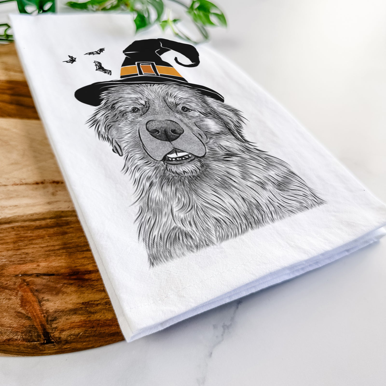 Hand-drawn sketch of Ralph the Leonberger wearing a witch hat on a tea towel