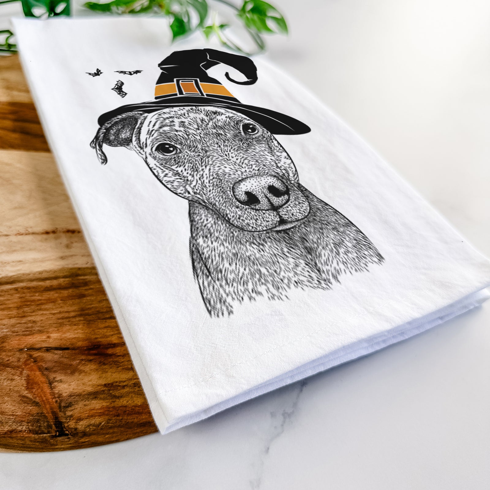 Hand-drawn sketch of Reeses the Pitbull wearing a witch hat on a tea towel