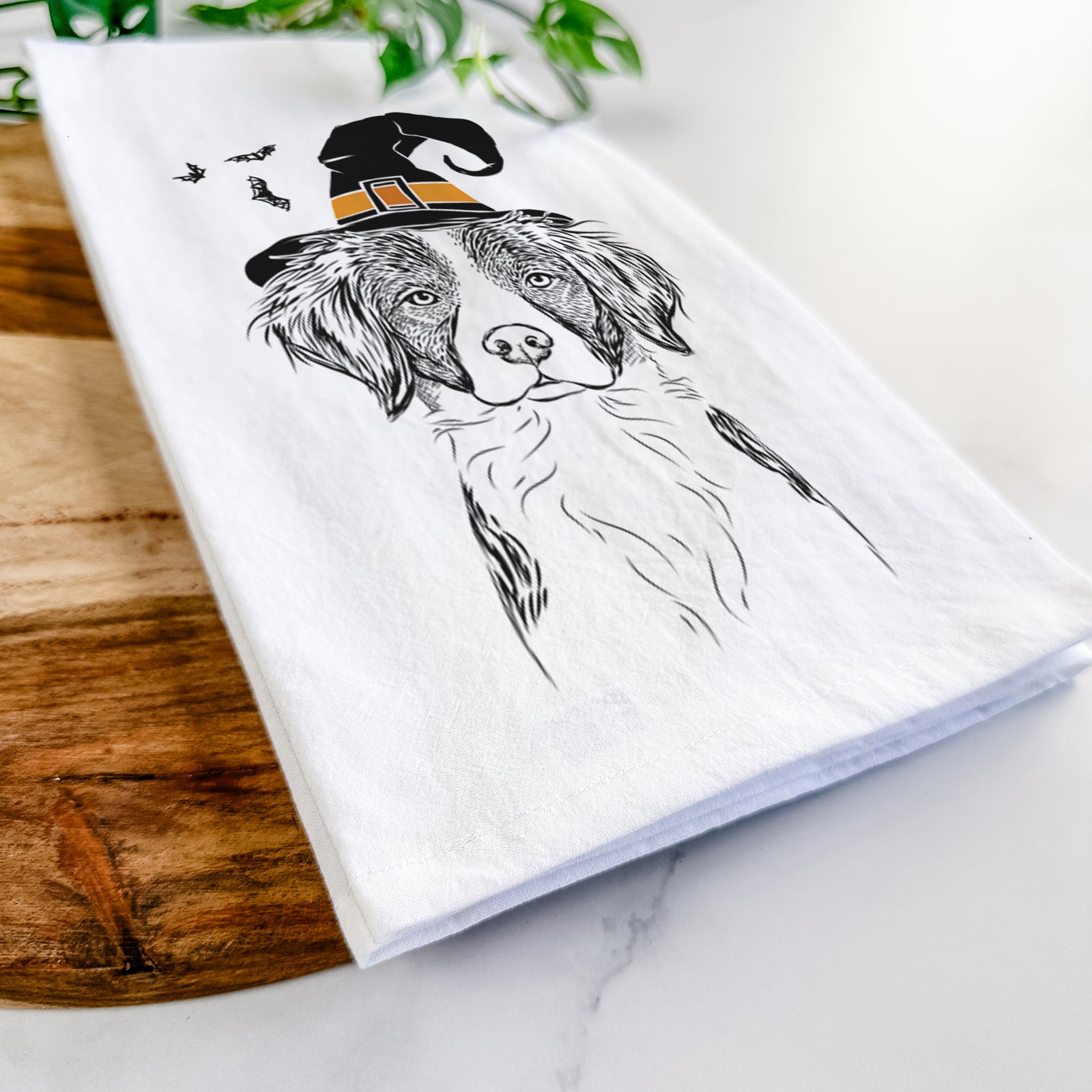 Hand-drawn sketch of Remi the Brittany wearing a witch hat on a tea towel