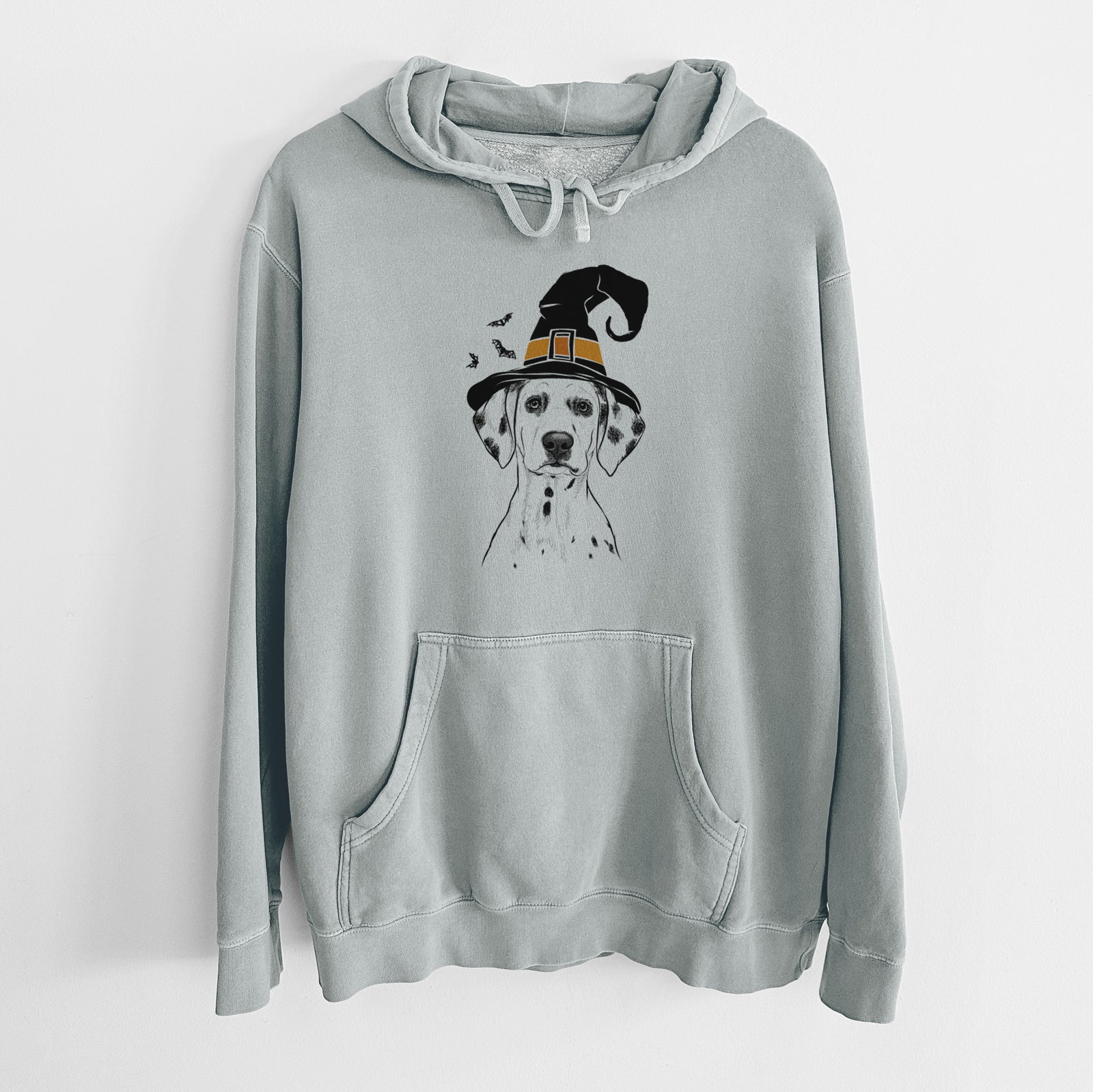 Hand-drawn sketch of Riot the Dalmatian wearing a witch hat on a Sage Unisex pigment dyed hoodie
