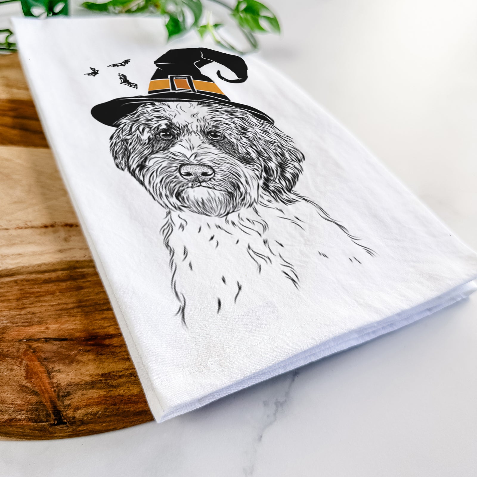 Hand-drawn sketch of Rooney the Aussiedoodle wearing a witch hat on a tea towel