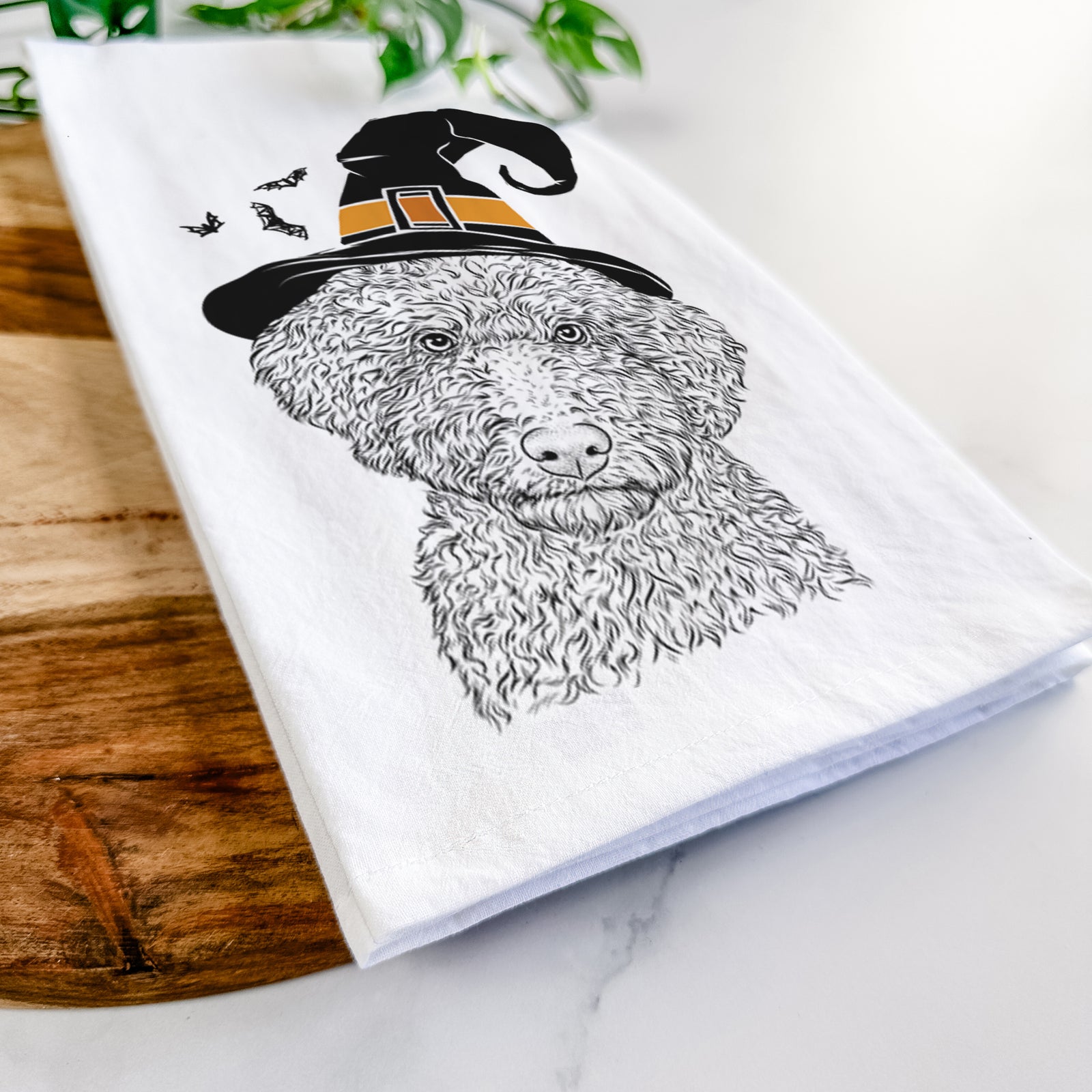 Hand-drawn sketch of Ross the Lagotto Romagnolo wearing a witch hat on a tea towel