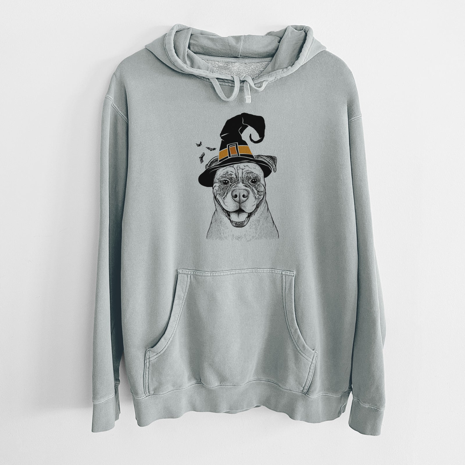 Hand-drawn sketch of Rufus the American Bulldog wearing a witch hat on a Sage Unisex pigment dyed hoodie