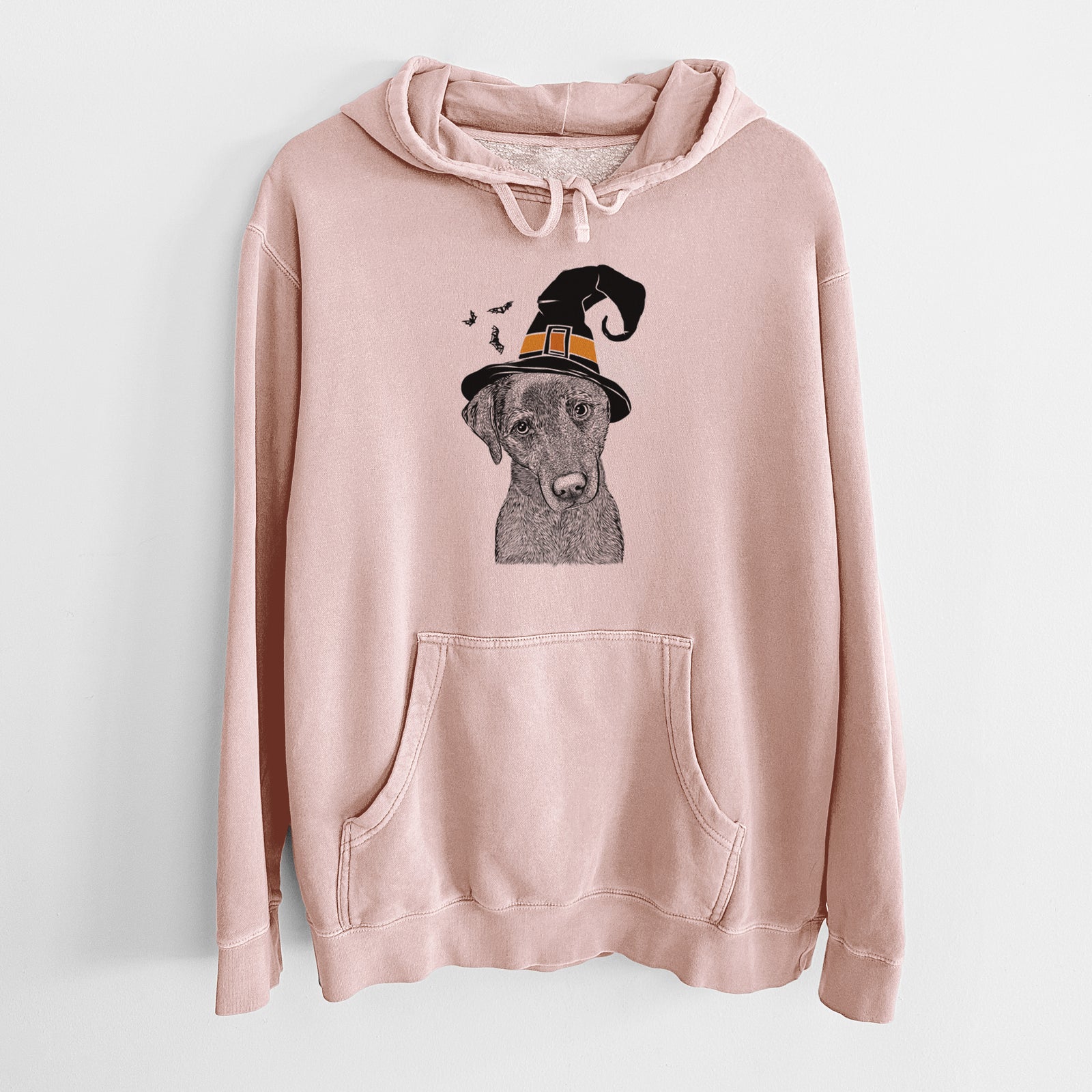 Hand-drawn sketch of Sadie the Whipador wearing a witch hat on a Dusty Pink Unisex pigment dyed hoodie