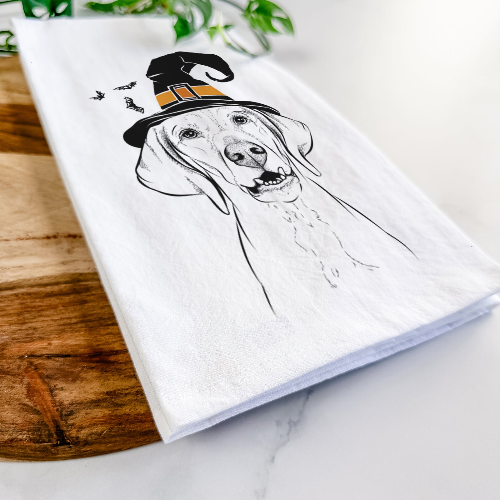 Hand-drawn sketch of Sarge the Vizsla wearing a witch hat on a tea towel