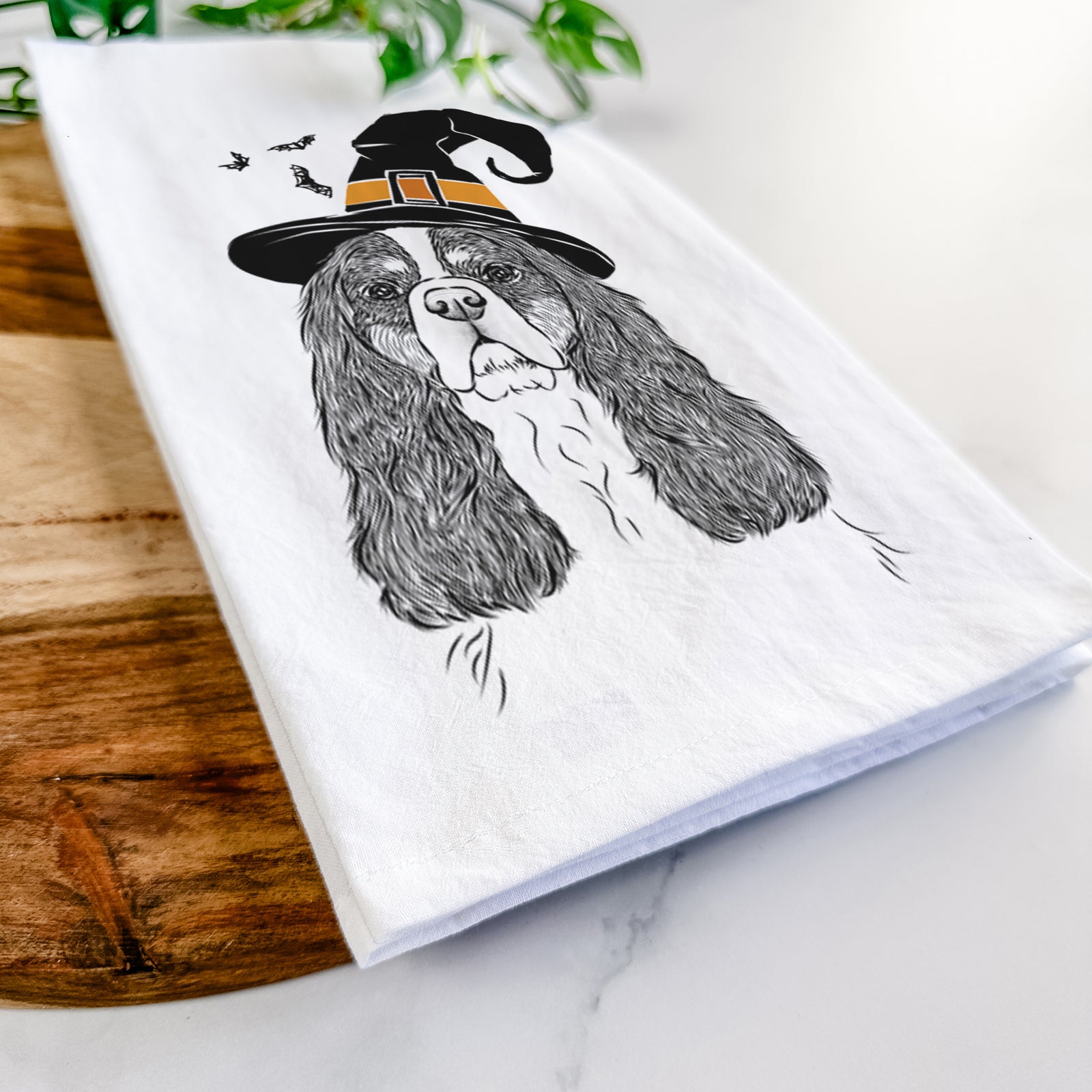 Hand-drawn sketch of Sebastian the Cavalier King Charles Spaniel wearing a witch hat on a tea towel
