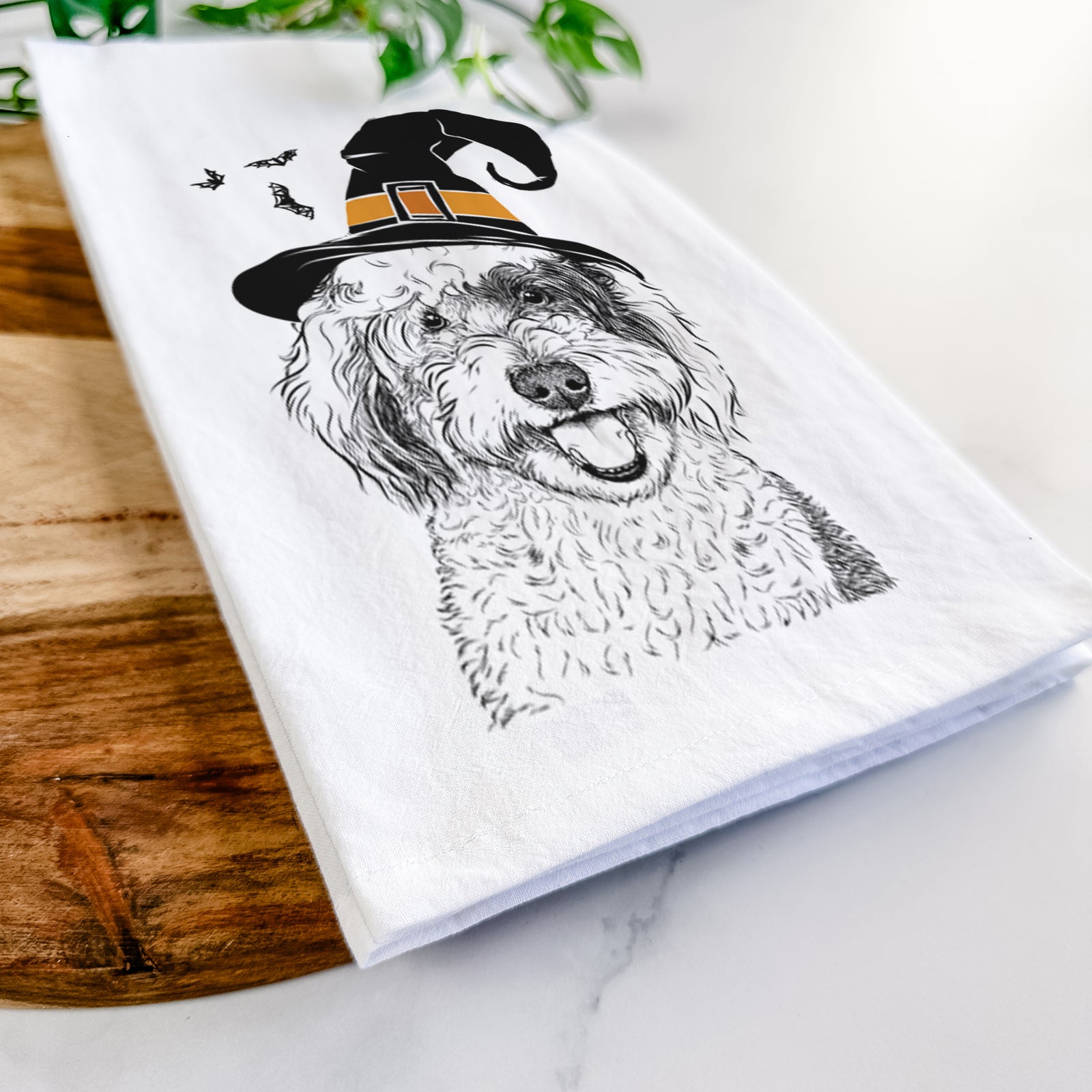 Hand-drawn sketch of Sherlock the Sheepadoodle wearing a witch hat on a tea towel