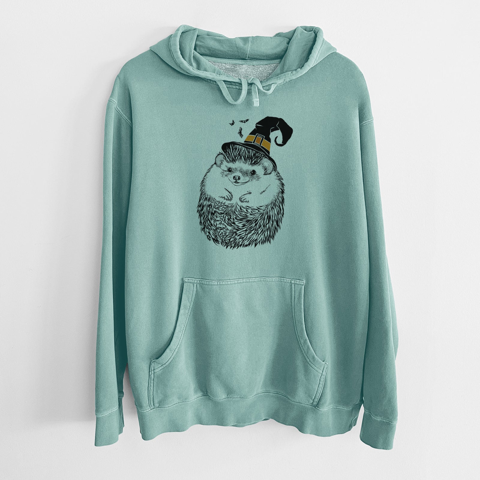 Hand-drawn sketch of Sid the Hedgehog wearing a witch hat on a Mint Unisex pigment dyed hoodie