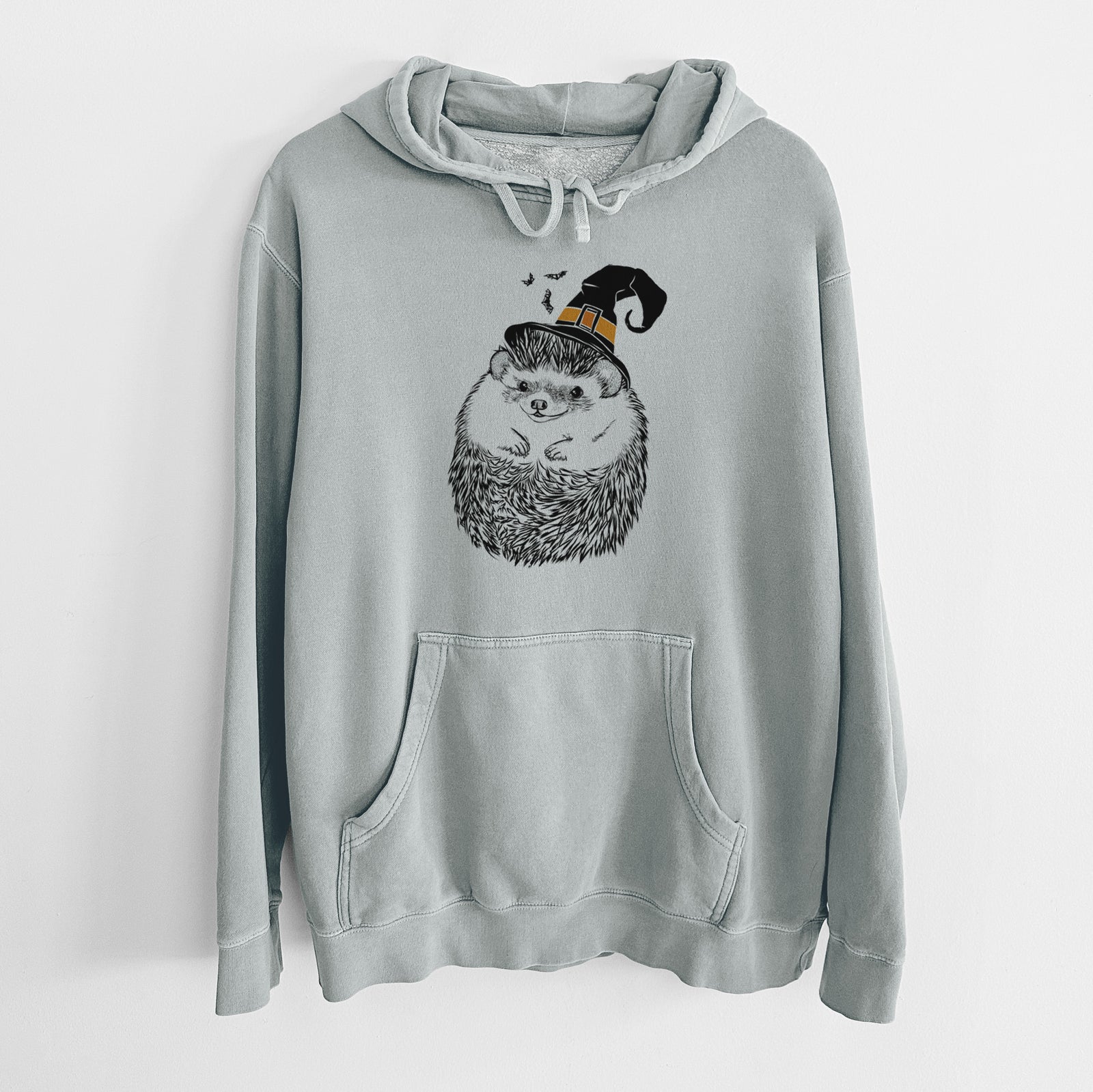 Hand-drawn sketch of Sid the Hedgehog wearing a witch hat on a Sage Unisex pigment dyed hoodie