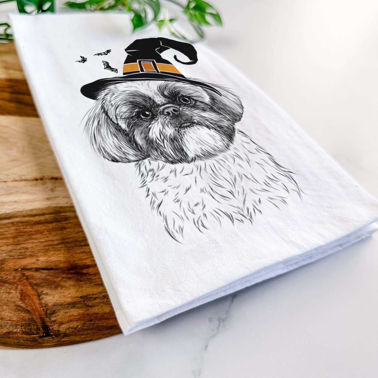 Hand-drawn sketch of Simon the Shih Tzu wearing a witch hat on a tea towel