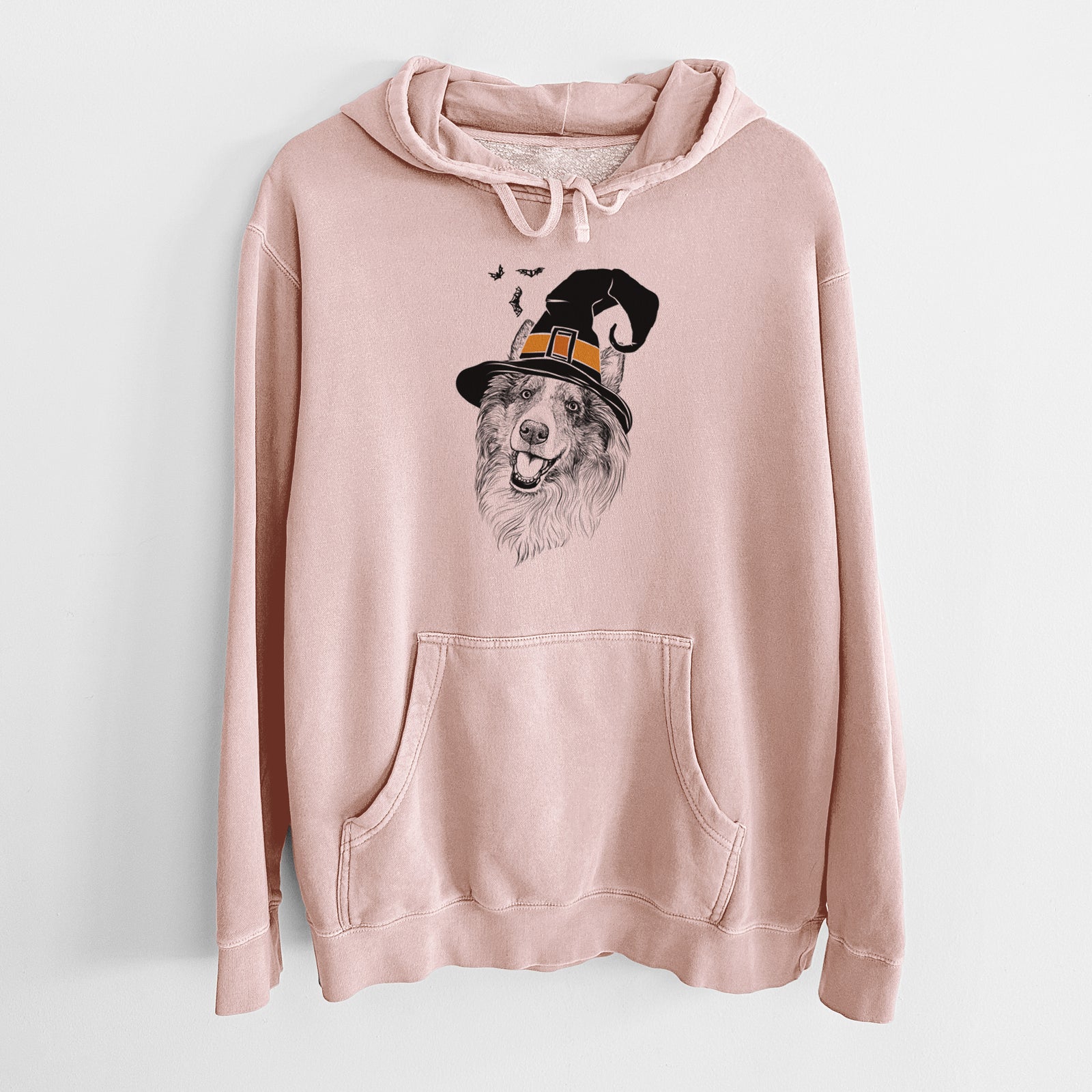 Hand-drawn sketch of Skylar the Shetland Sheepdog wearing a witch hat on a Dusty Pink Unisex pigment dyed hoodie