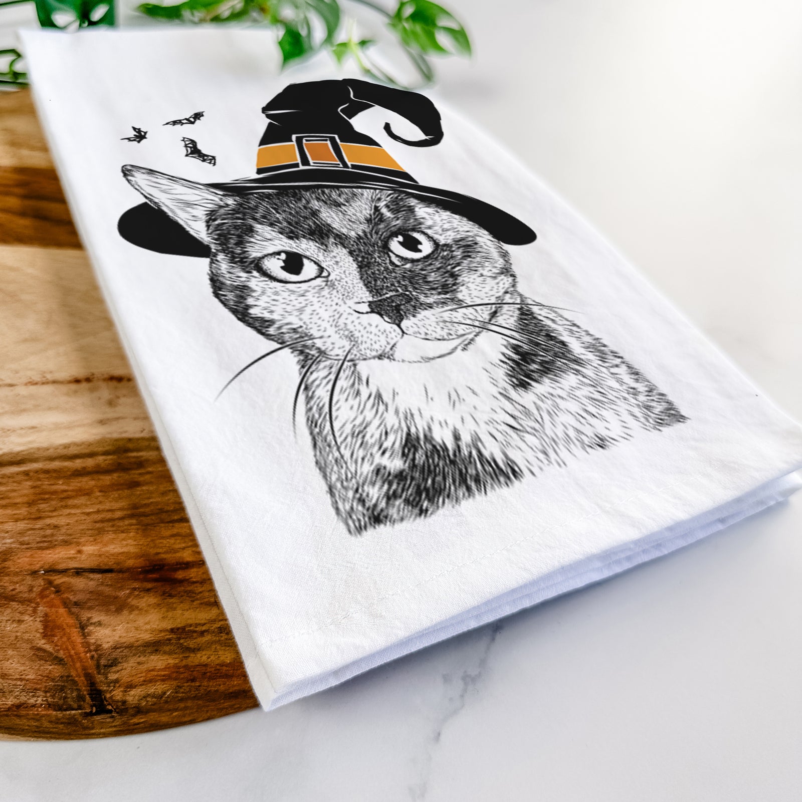 Hand-drawn sketch of Spooky Kitty the Tortoiseshell Cat wearing a witch hat on a tea towel