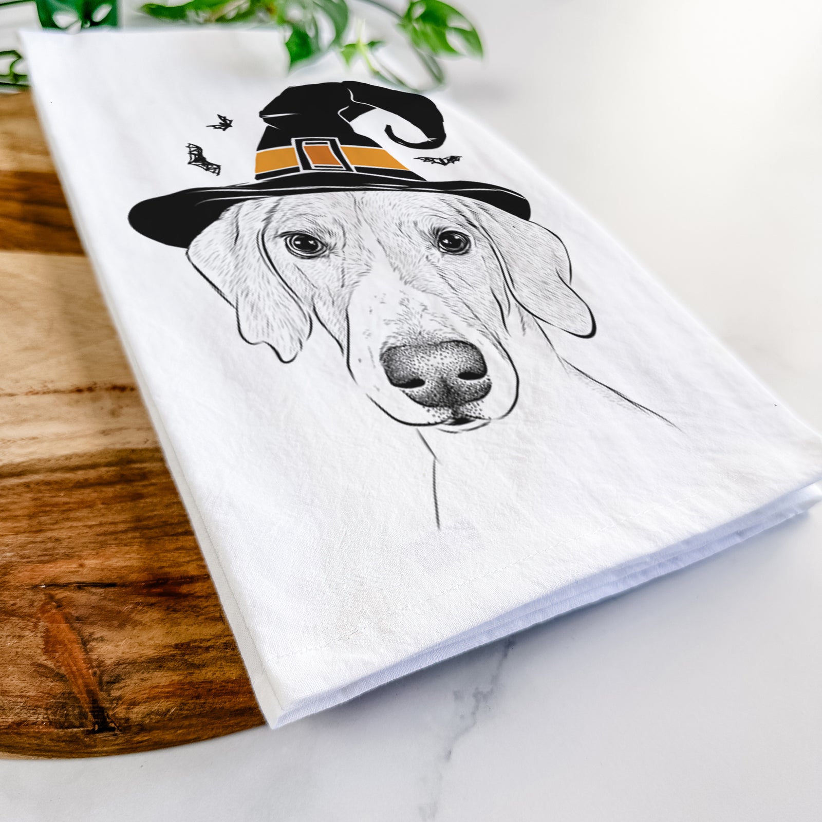 Hand-drawn sketch of Stanley the Foxhound wearing a witch hat on a tea towel