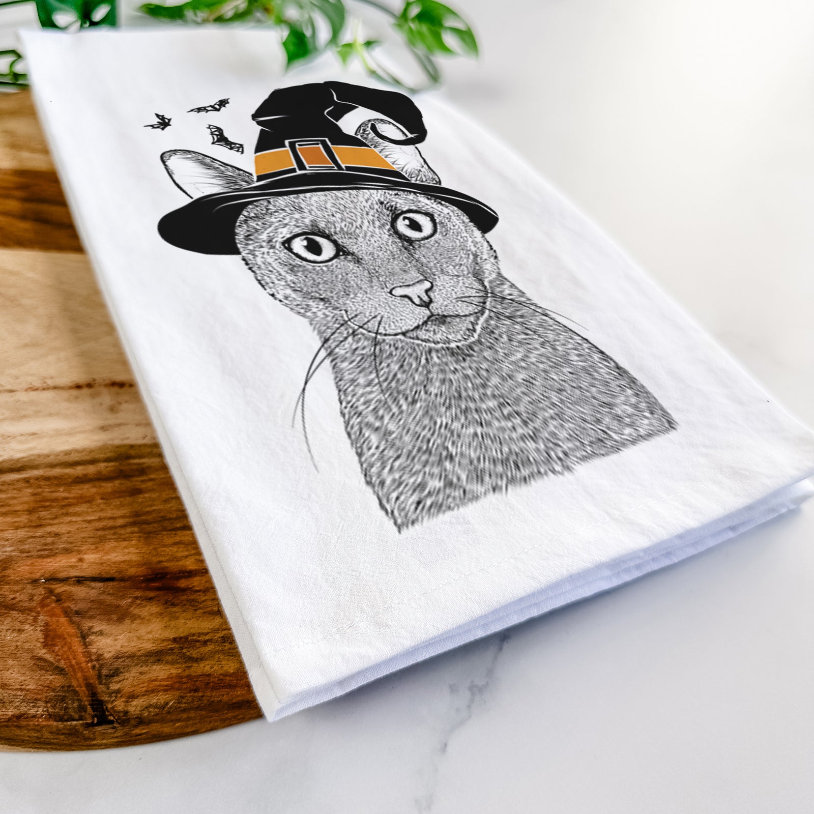 Hand-drawn sketch of Stanley the Russian Blue Cat wearing a witch hat on a tea towel