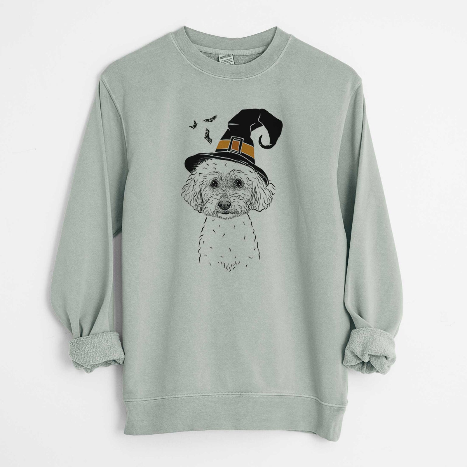 Hand-drawn sketch of Stitch the Bichonpoo wearing a witch hat on a Sage Unisex pigment dyed crew sweatshirt