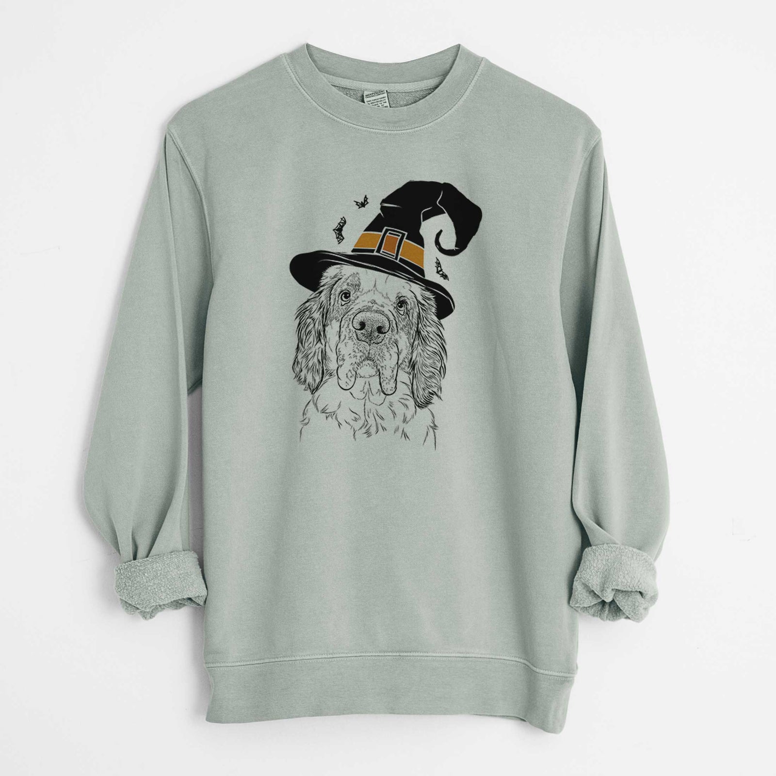 Hand-drawn sketch of Sully the Clumber Spaniel wearing a witch hat on a Sage Unisex pigment dyed crew sweatshirt