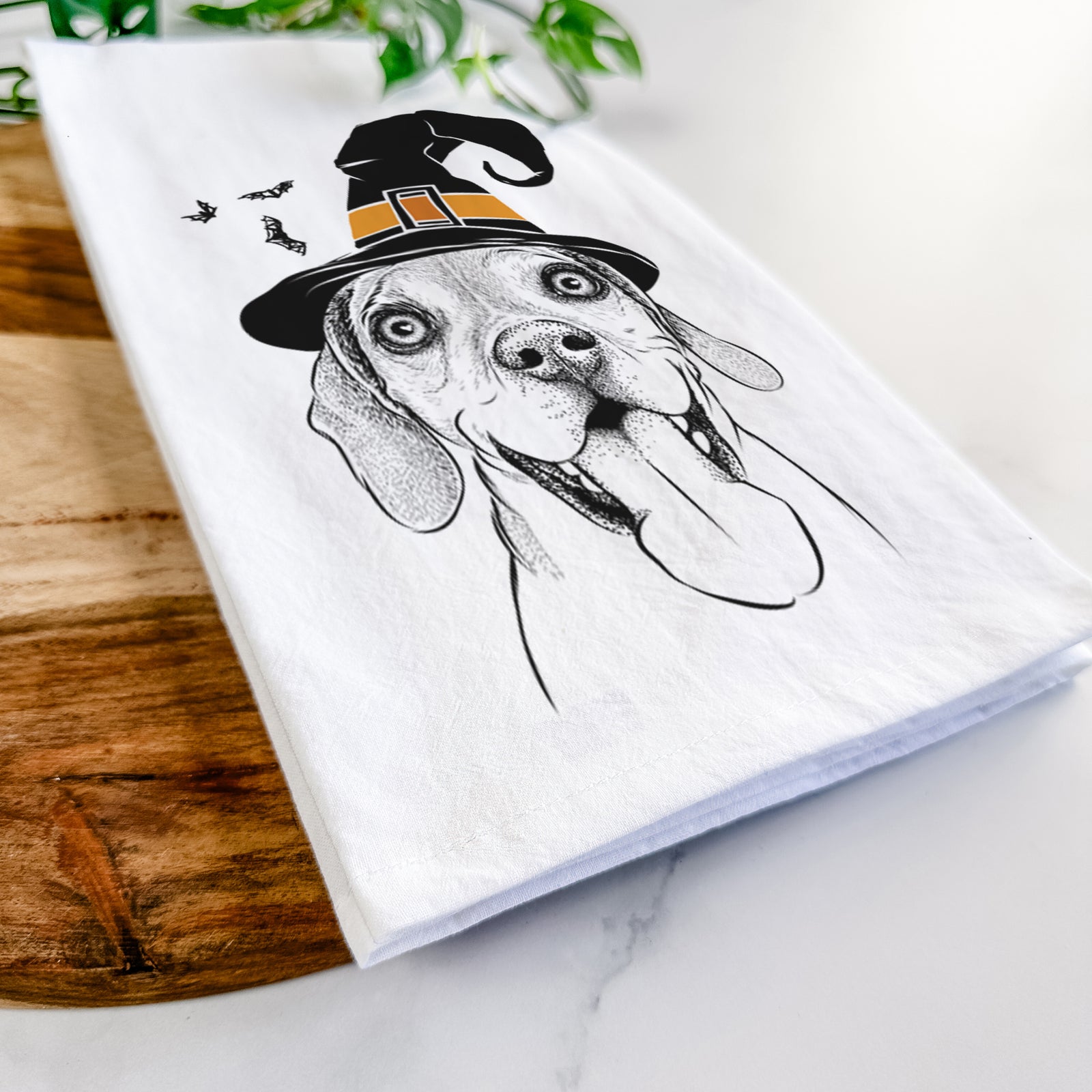 Hand-drawn sketch of Sunny the Beagle wearing a witch hat on a tea towel