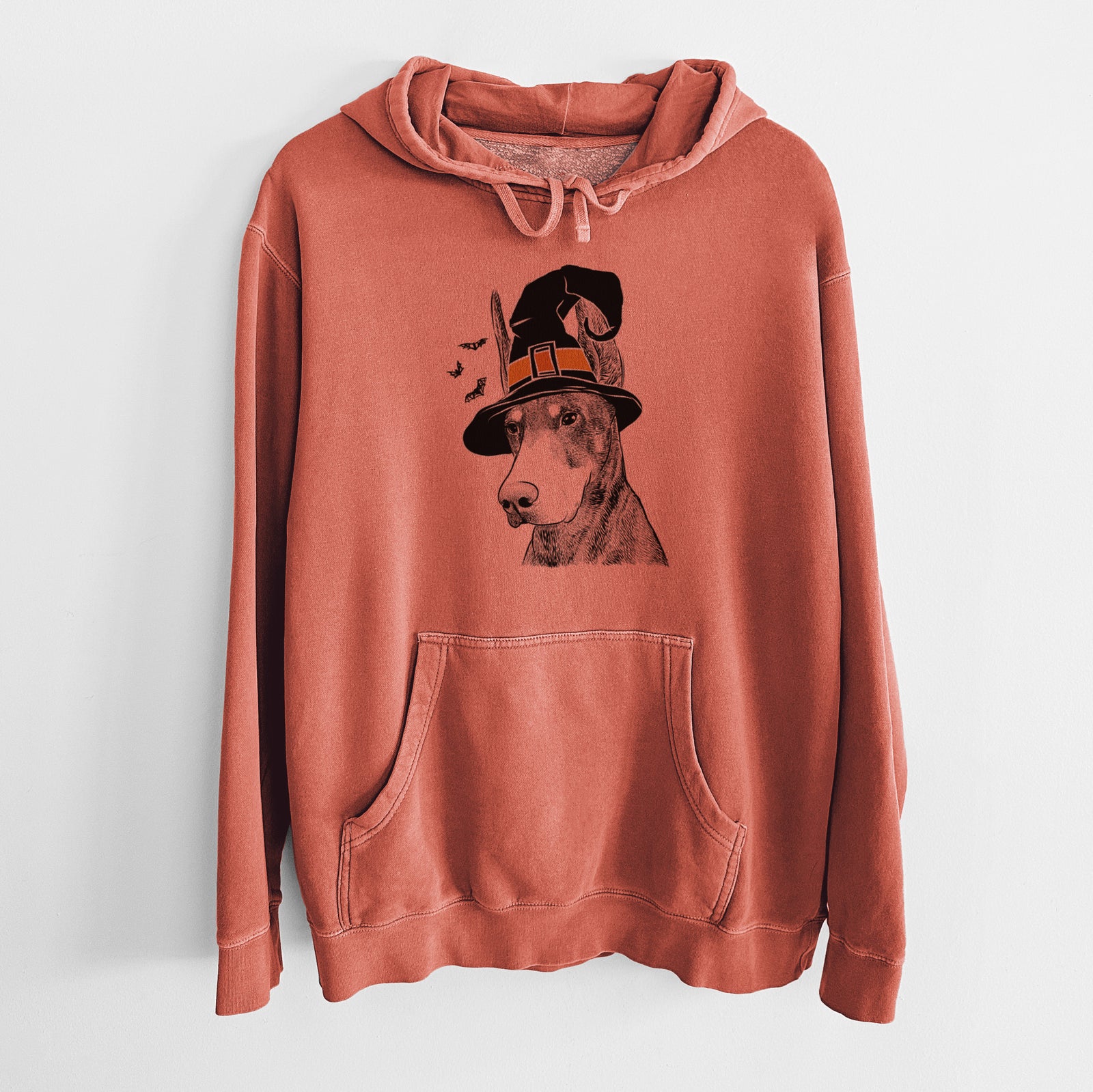 Hand-drawn sketch of Sunny the Doberman Pinscher wearing a witch hat on an Amber Unisex pigment dyed hoodie