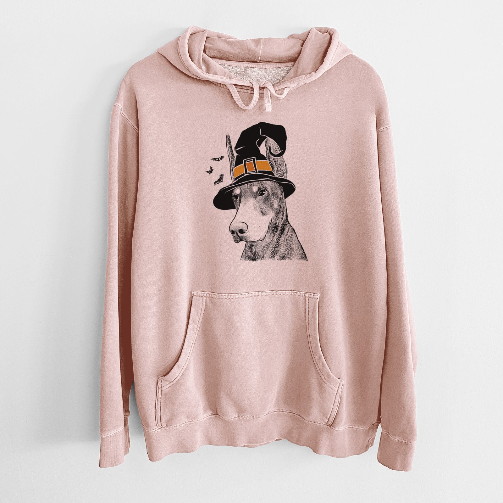 Hand-drawn sketch of Sunny the Doberman Pinscher wearing a witch hat on a Dusty Pink Unisex pigment dyed hoodie
