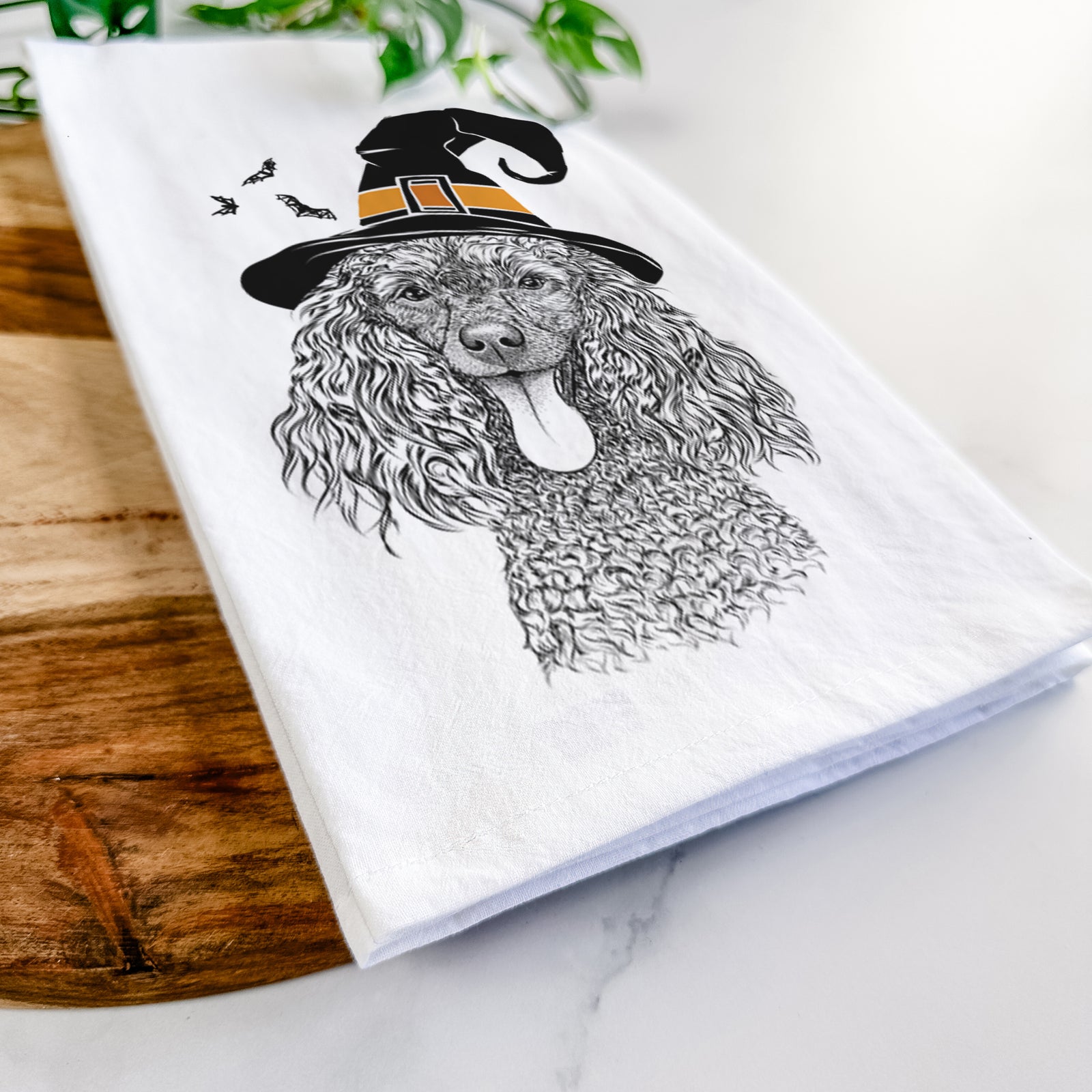 Hand-drawn sketch of Teddy the Mini Poodle wearing a witch hat on a tea towel