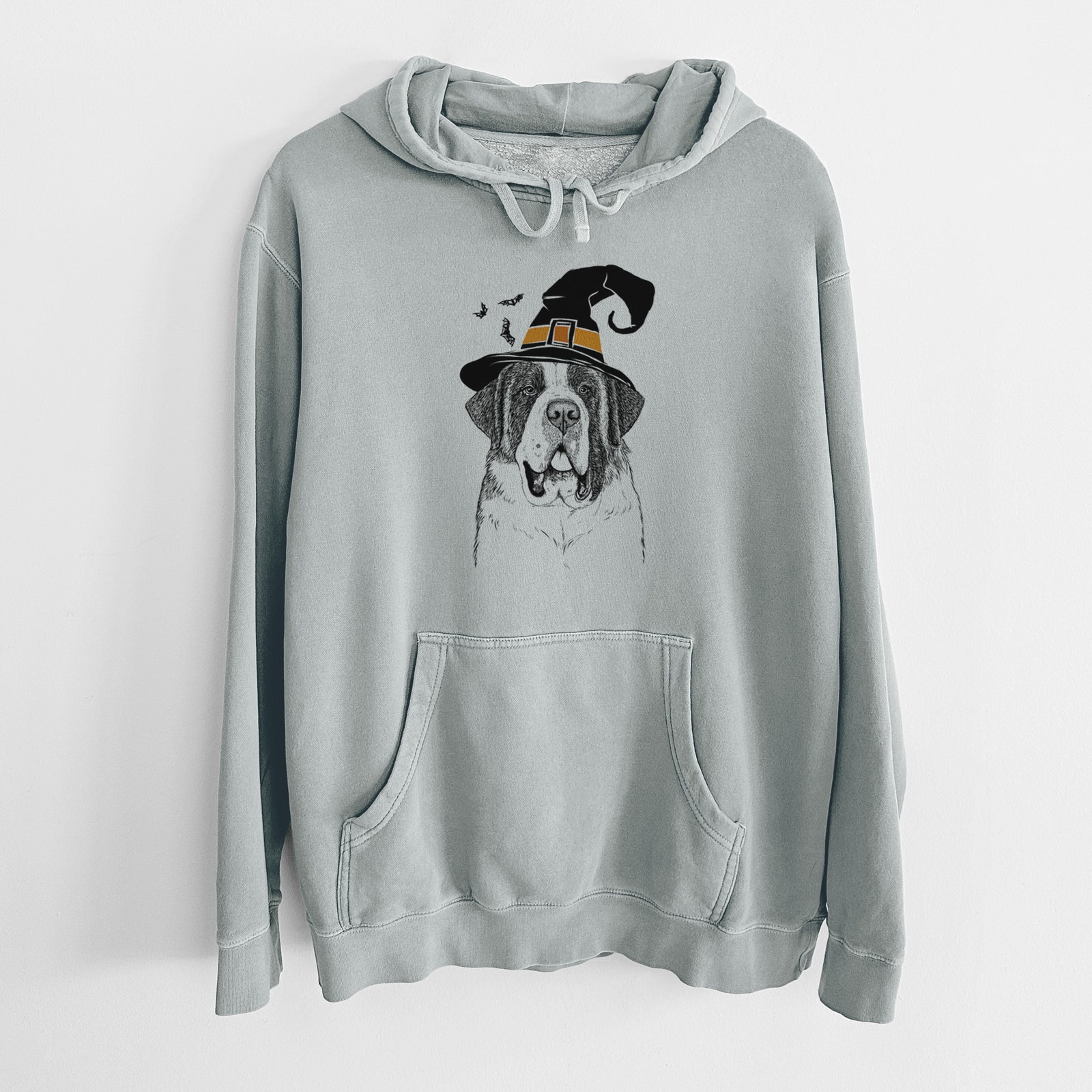 Hand-drawn sketch of Thor the Saint Bernard wearing a witch hat on a Sage Unisex pigment dyed hoodie