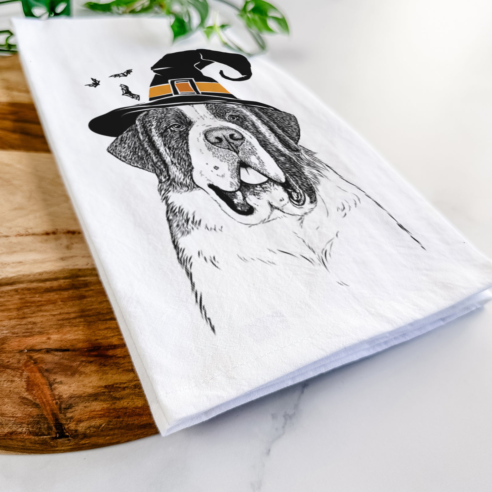Hand-drawn sketch of Thor the Saint Bernard wearing a witch hat on a tea towel