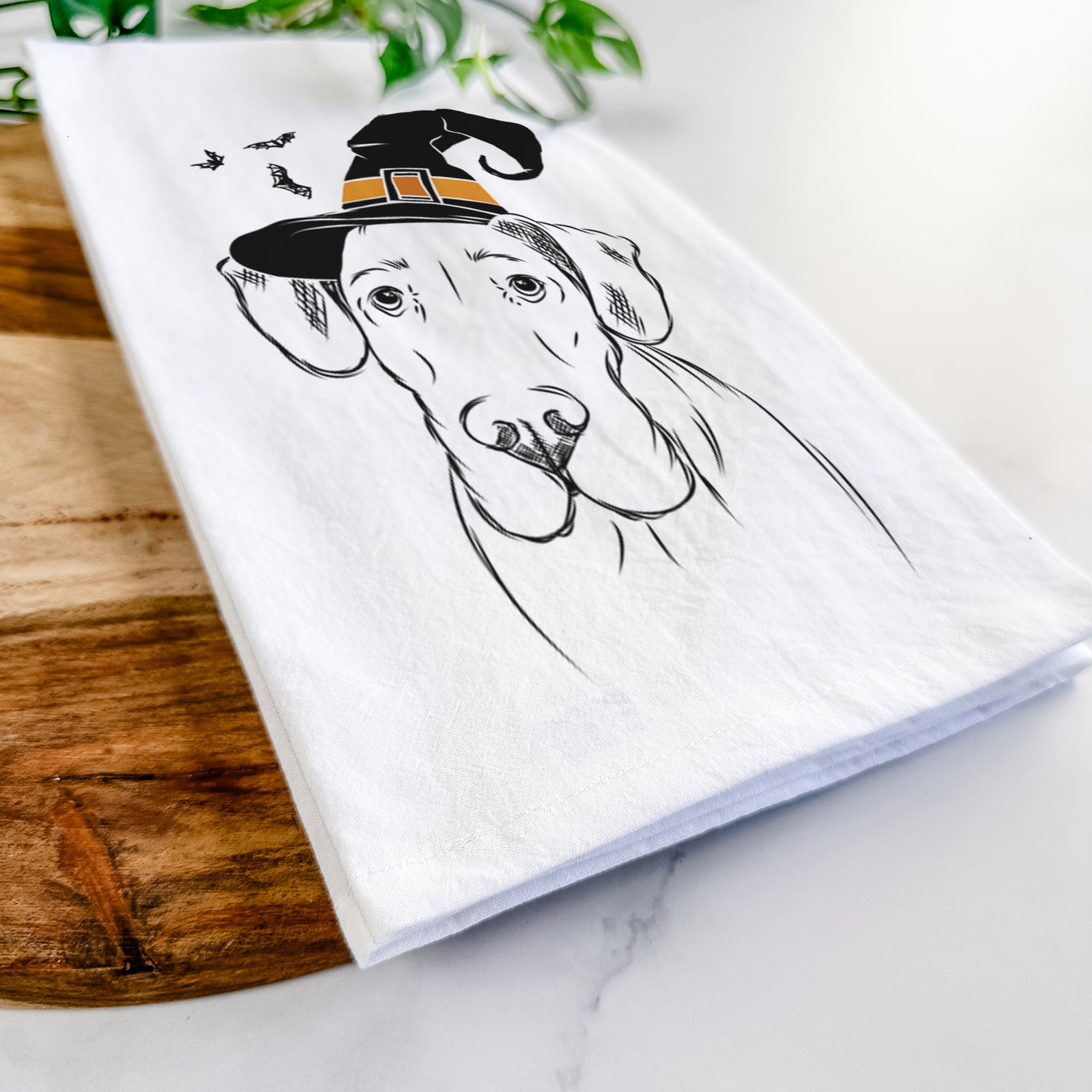 Hand-drawn sketch of Titus the Great Dane wearing a witch hat on a tea towel